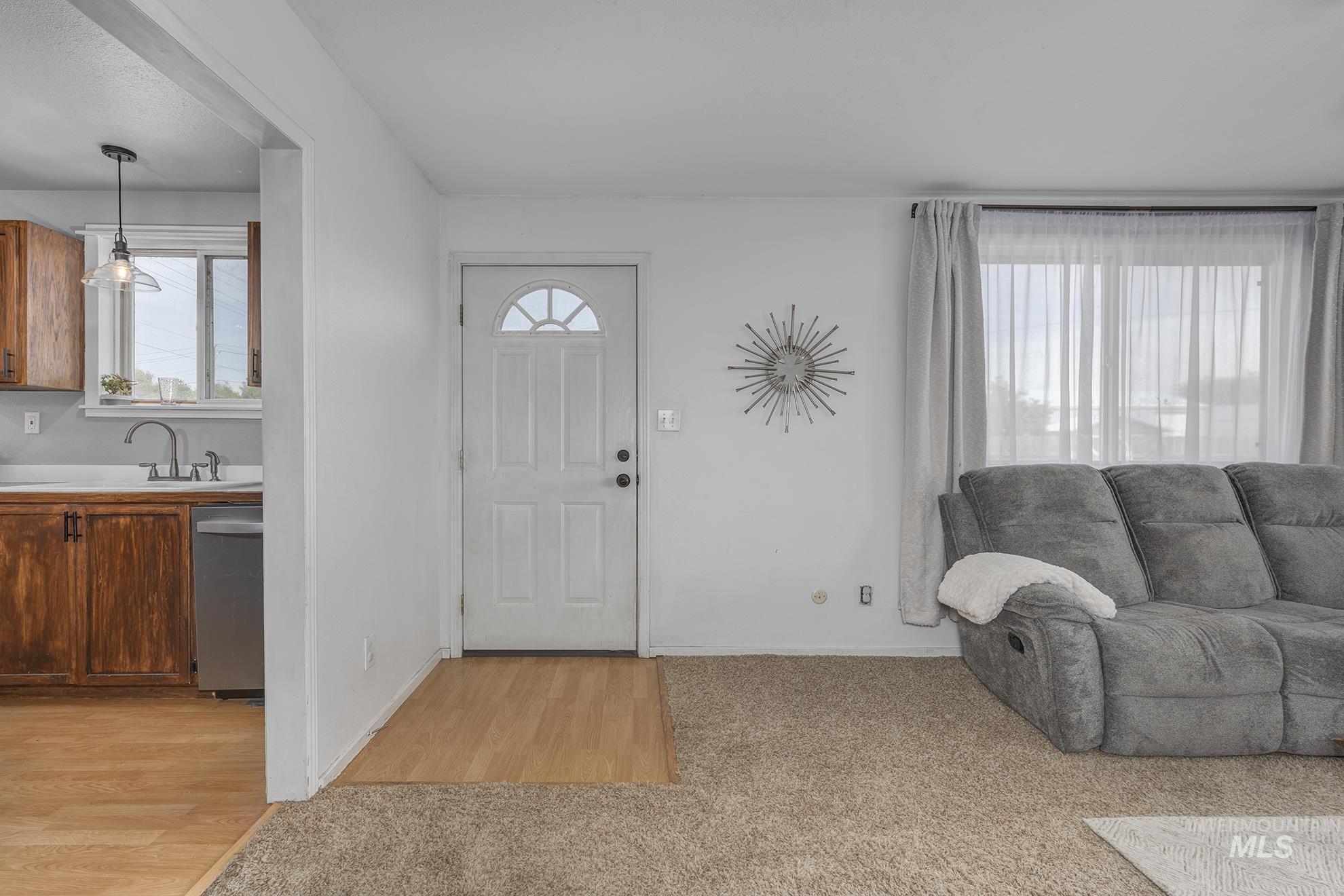 Foyer entrance featuring baseboards and light wood-style floors