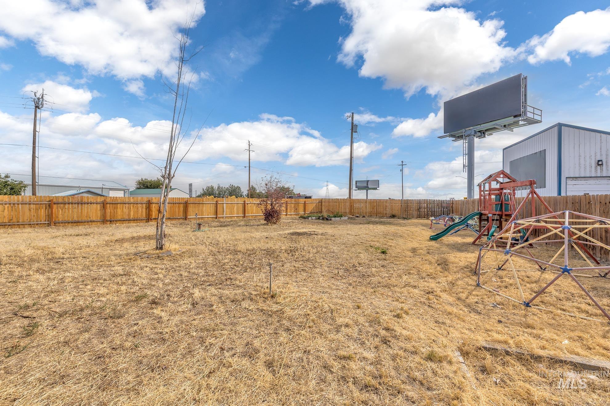 Fenced backyard with a playground