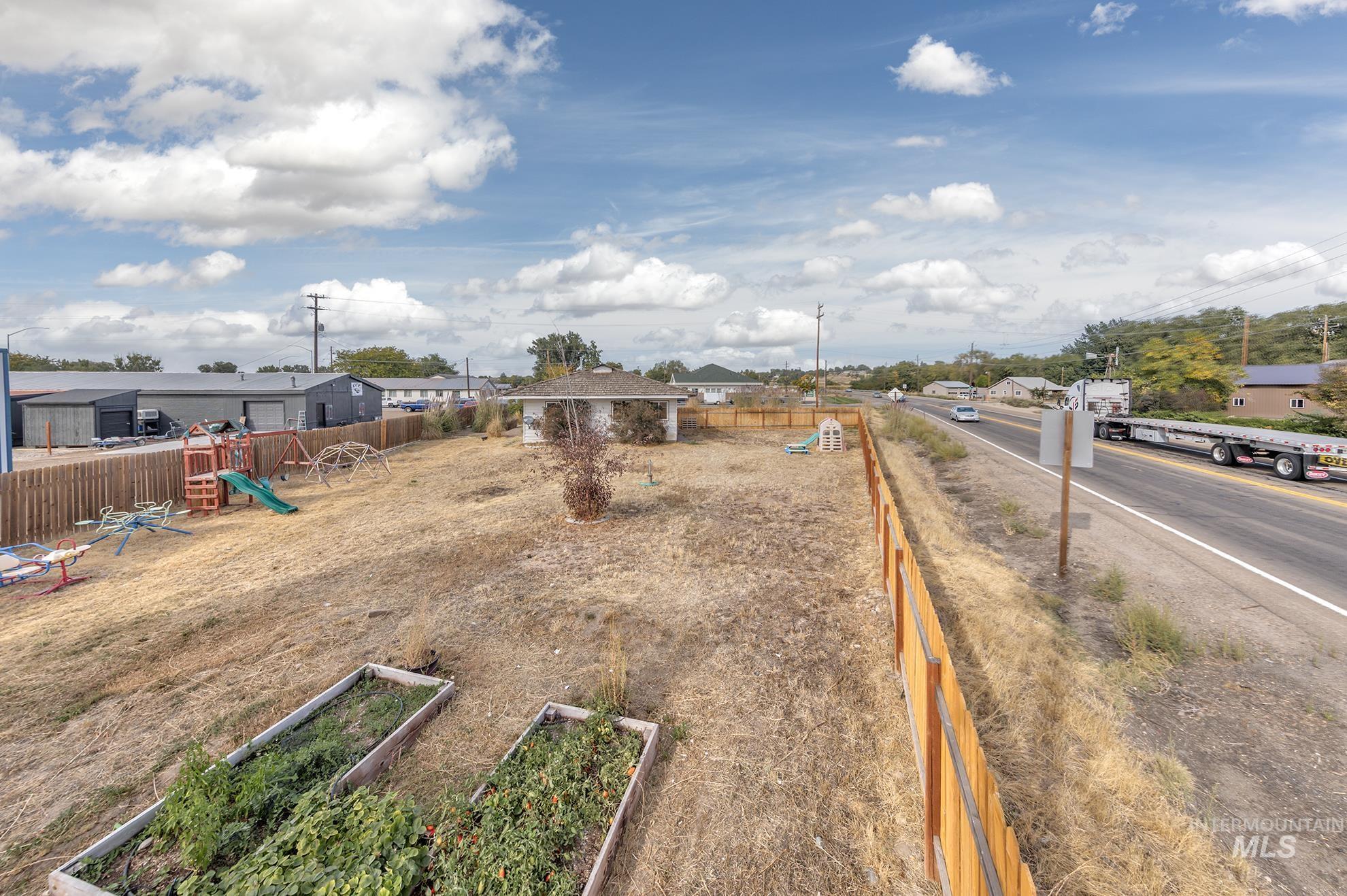 View of yard featuring a playground, a garden, and a residential view