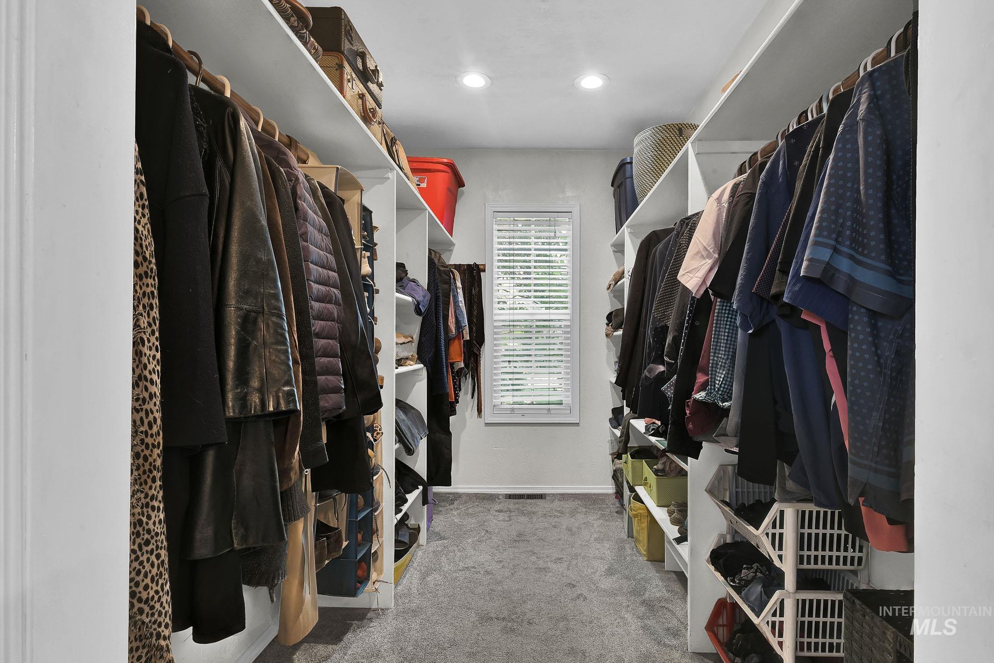 Spacious closet with light colored carpet