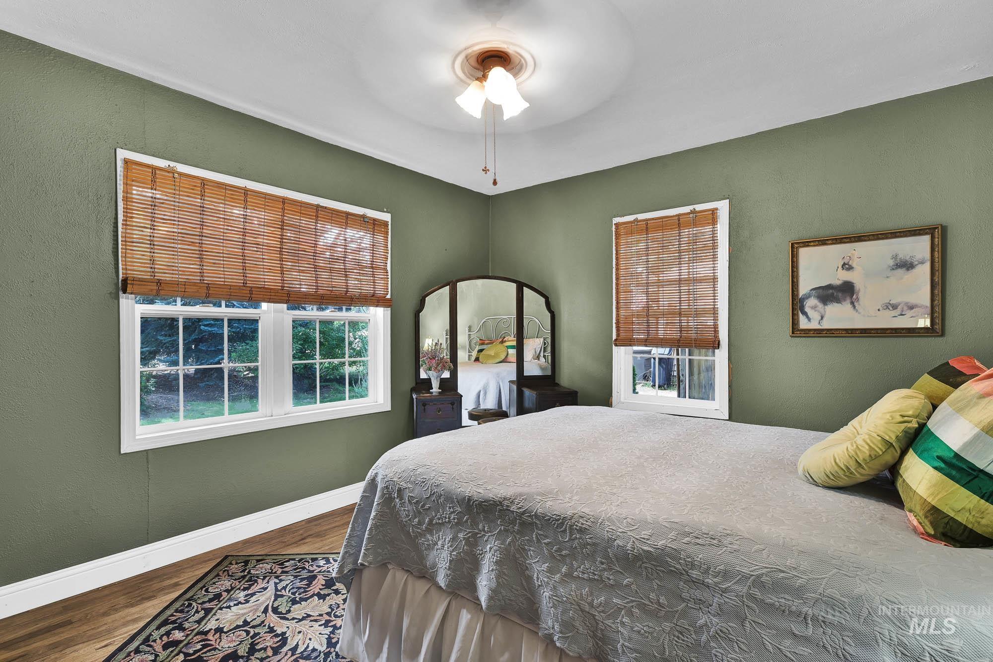 Bedroom with wood finished floors and a ceiling fan