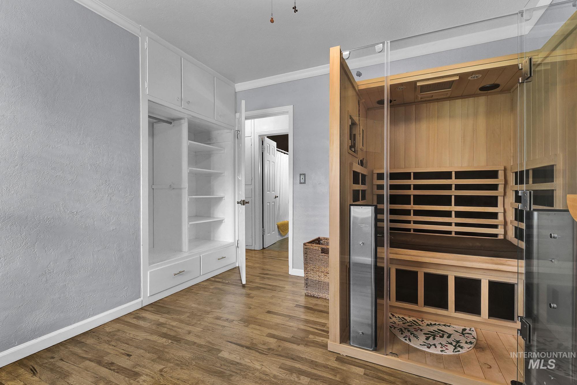 Hardwood finished floors and a textured wall - currently fits a nice sauna