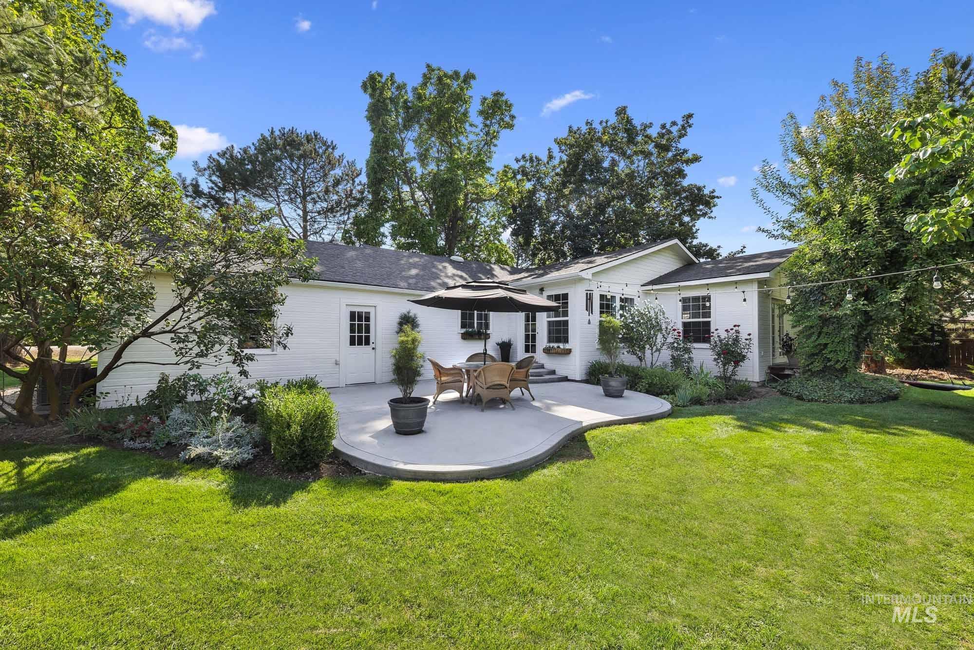 Rear view of property featuring a patio and a yard