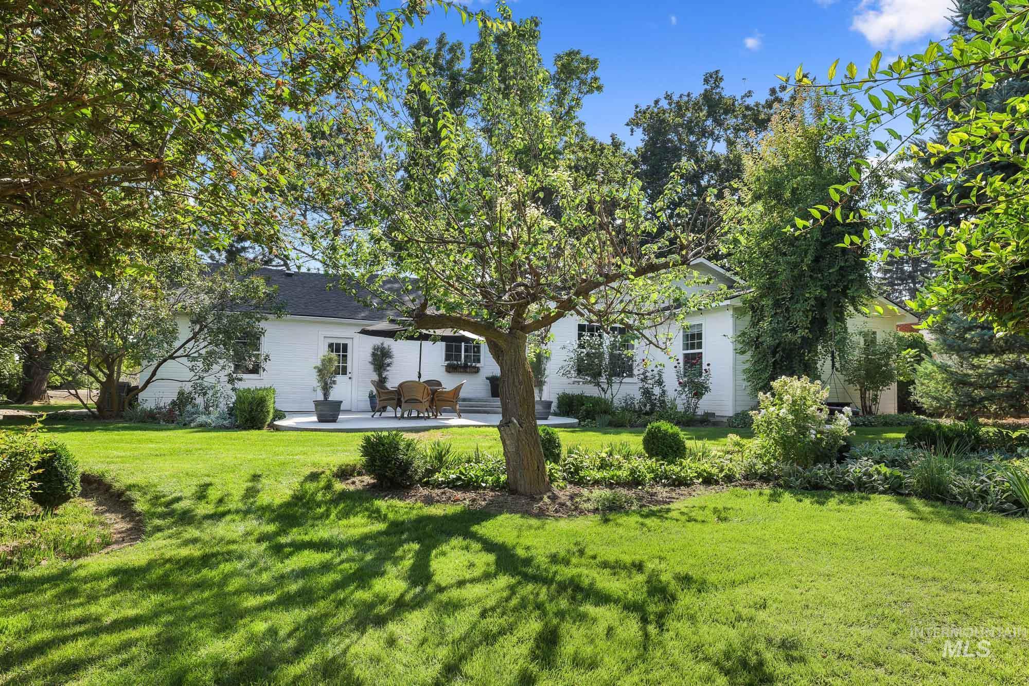 Rear view of property featuring a patio and a yard