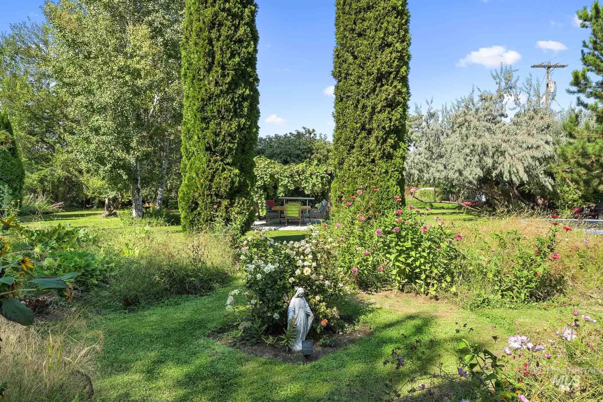 View from patio area into the yard and gardens