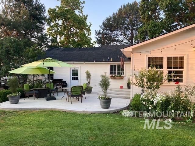 Rear view of house with a patio area, a yard, and outdoor lounge area