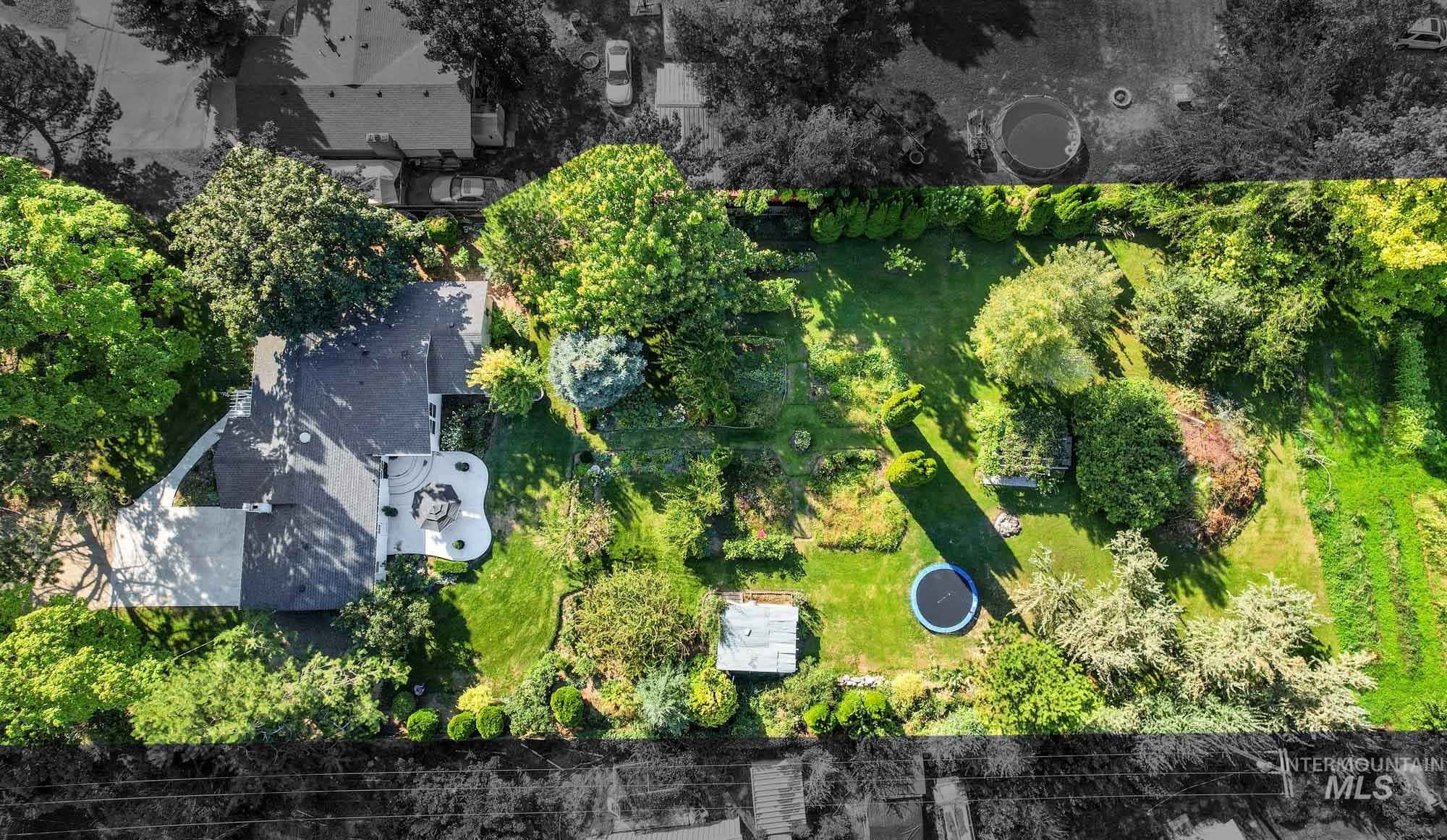Bird's eye view of the property overhead with pasture to the back of the acreage