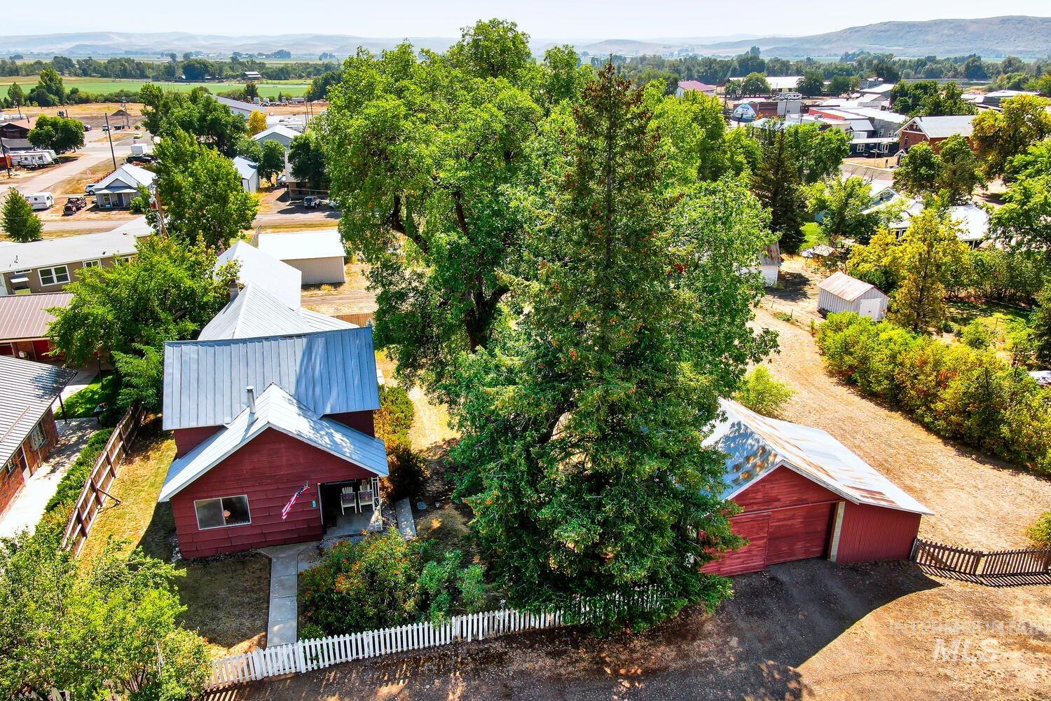 Aerial view of property and surrounding area with a mountain backdrop