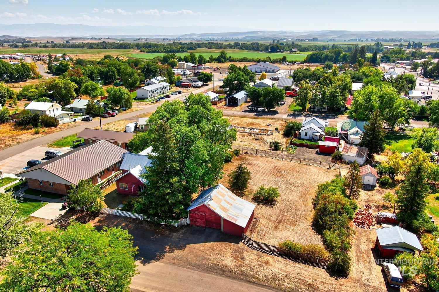 View of rural area with a mountainous background and nearby suburban area