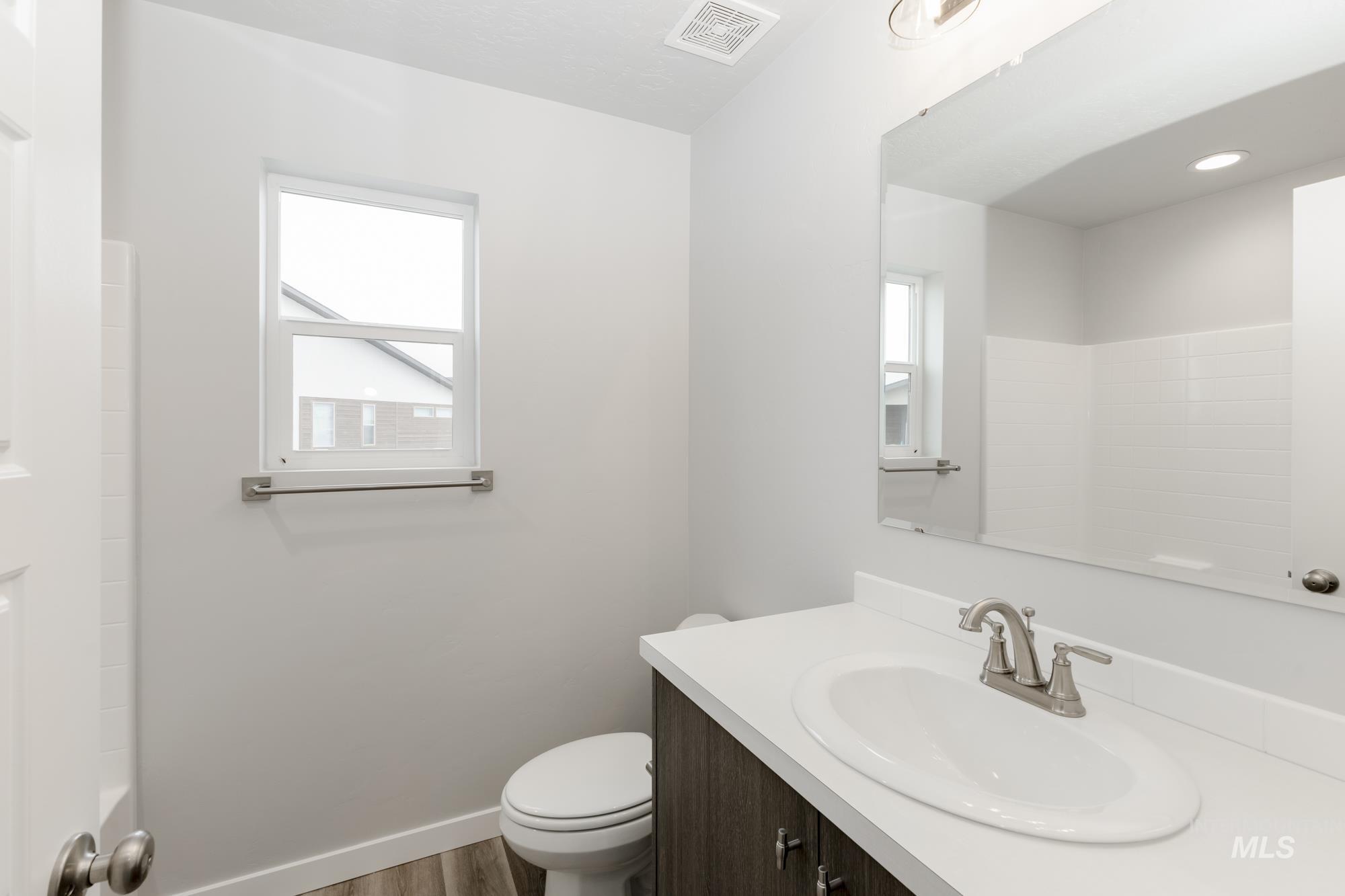 Bathroom featuring vanity and wood finished floors