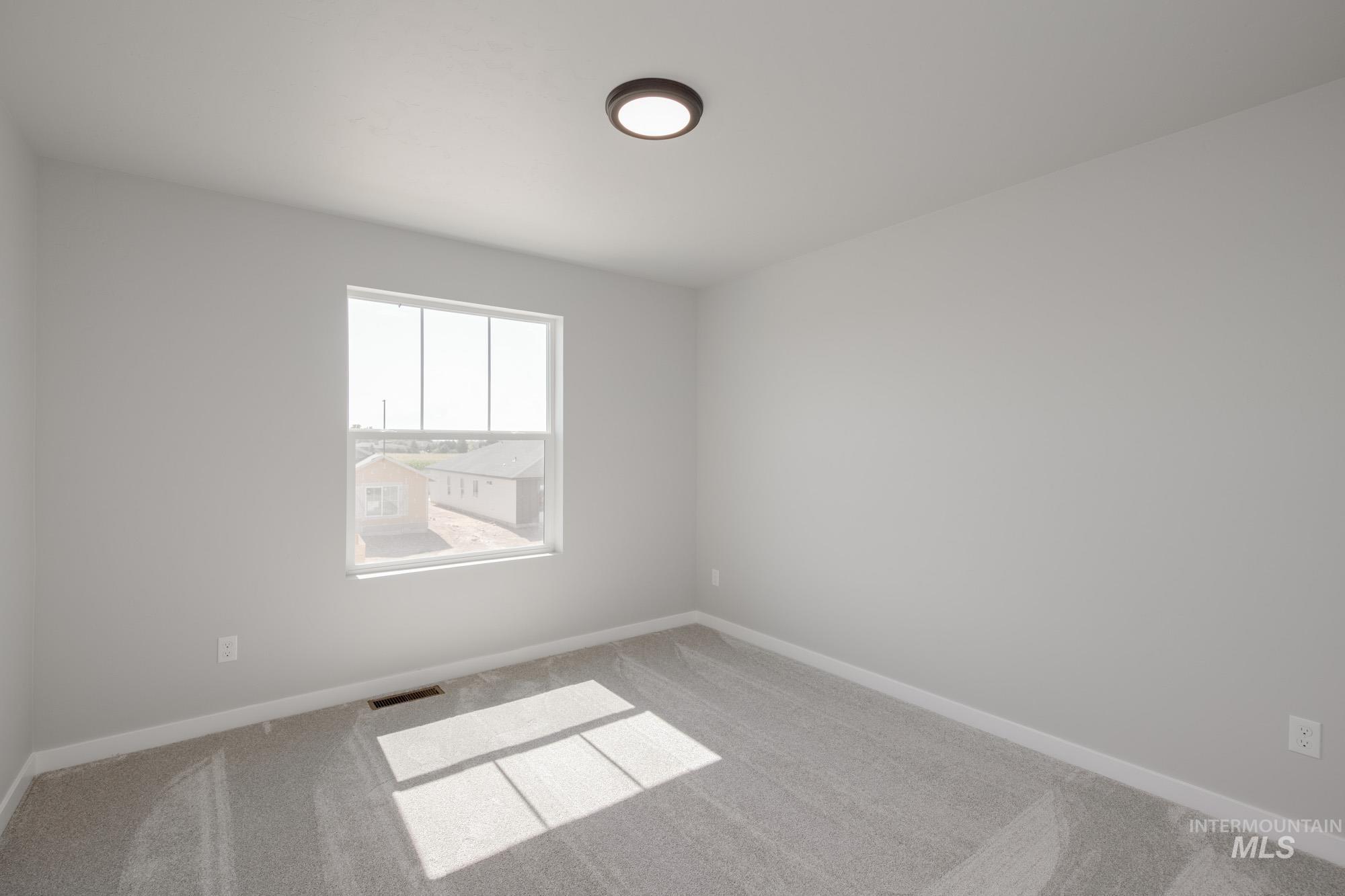 Unfurnished room with carpet flooring and baseboards