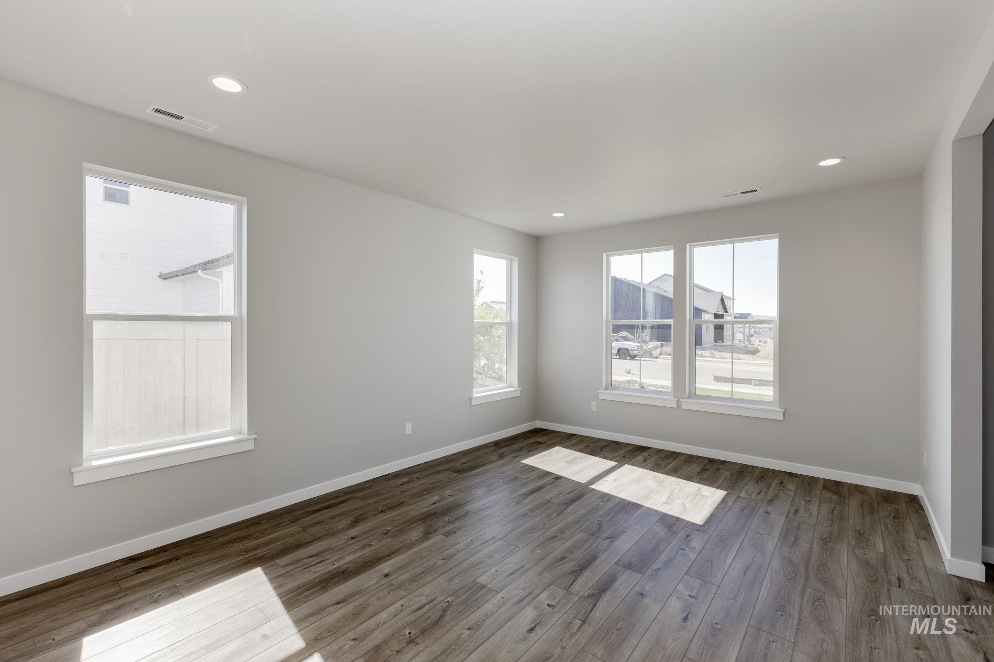 Spare room featuring wood finished floors and recessed lighting