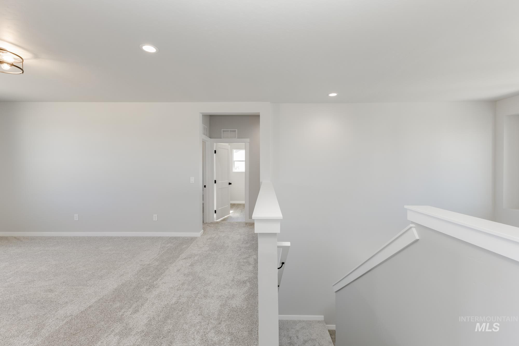 Staircase with carpet flooring and recessed lighting