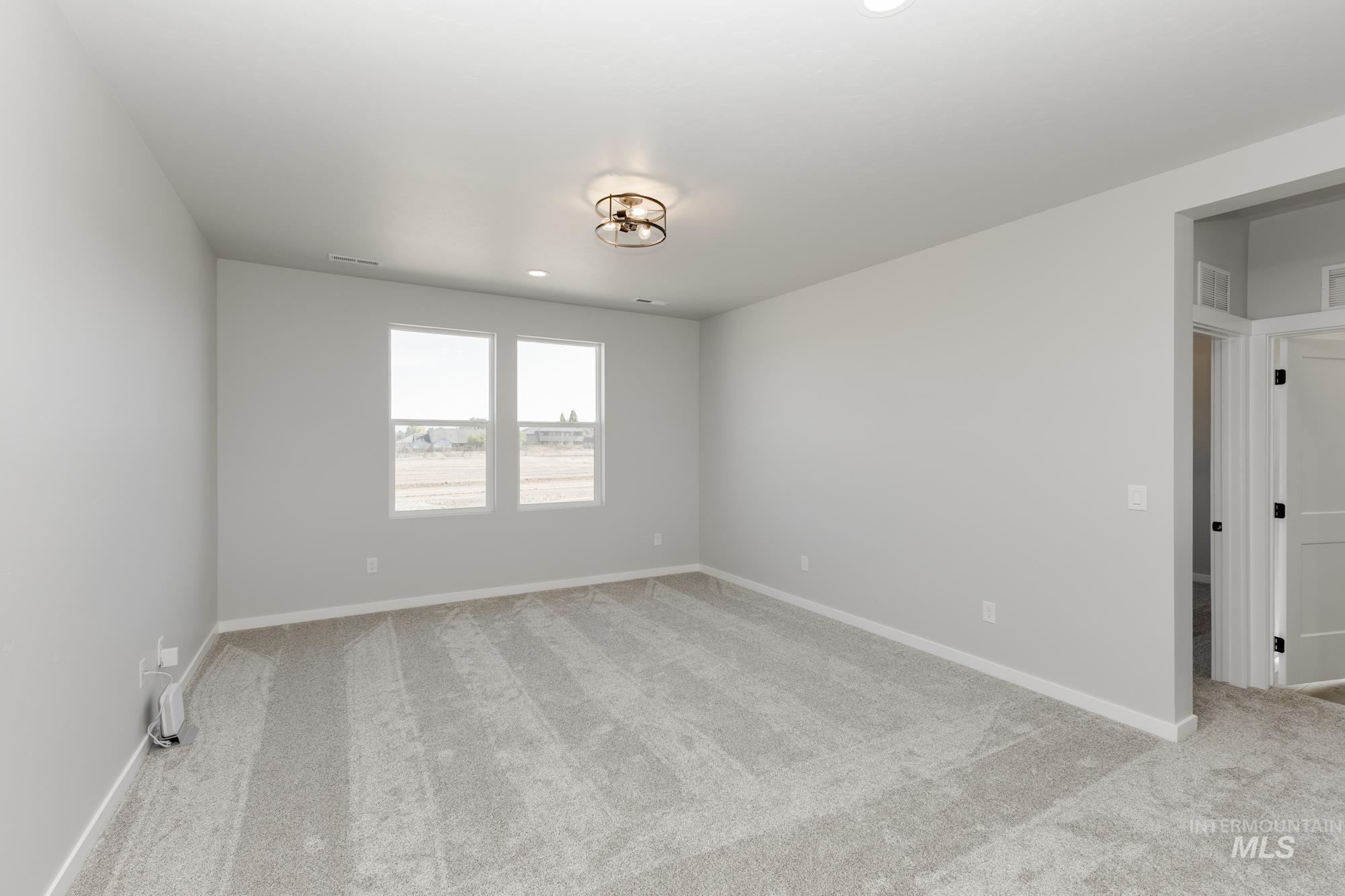 Unfurnished room featuring light colored carpet