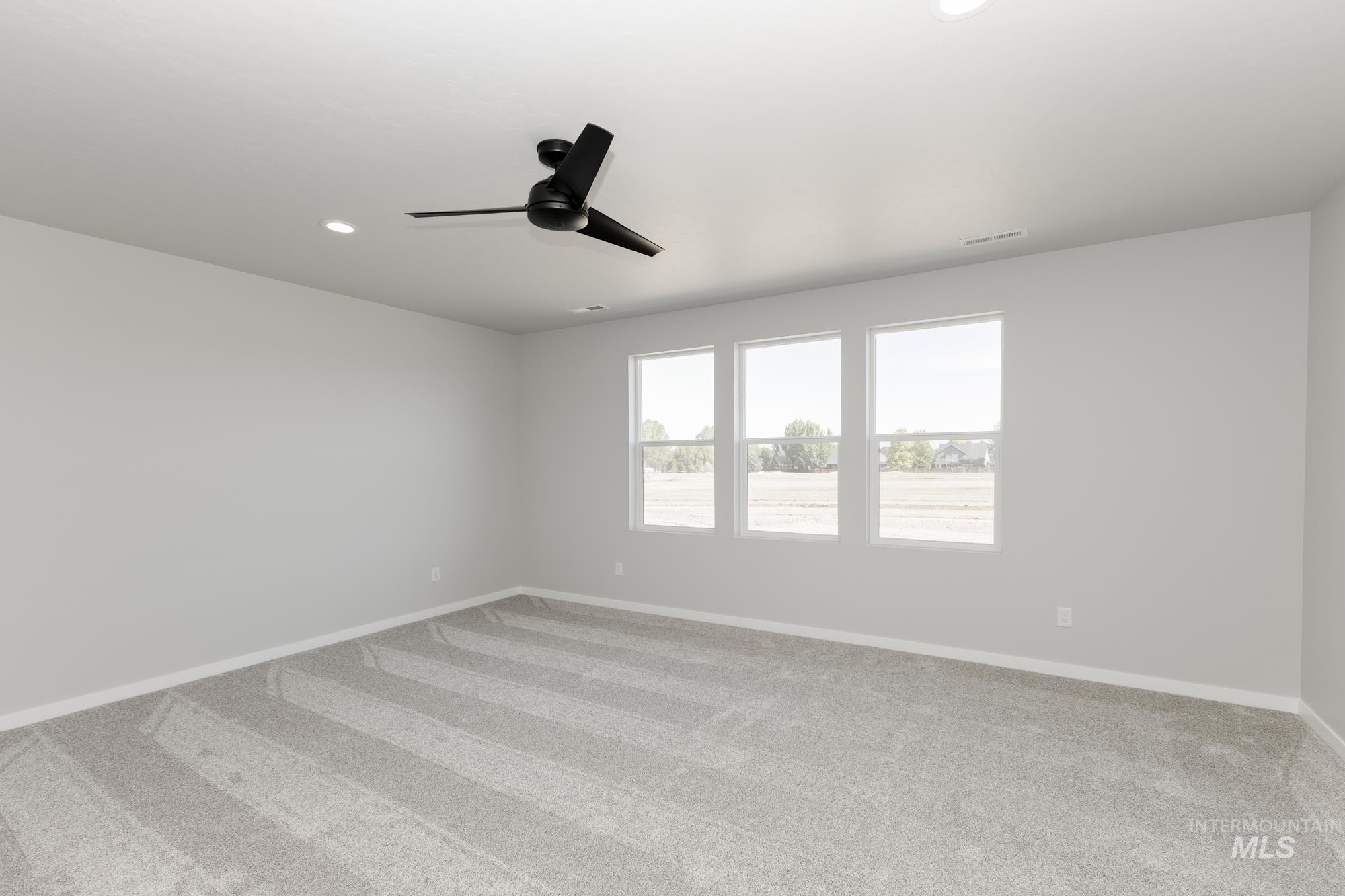 Unfurnished room with carpet flooring, a ceiling fan, and recessed lighting
