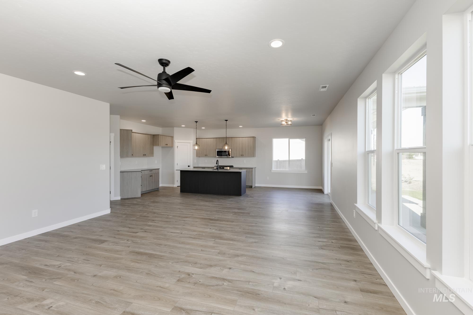 Unfurnished living room with light wood finished floors, recessed lighting, and ceiling fan
