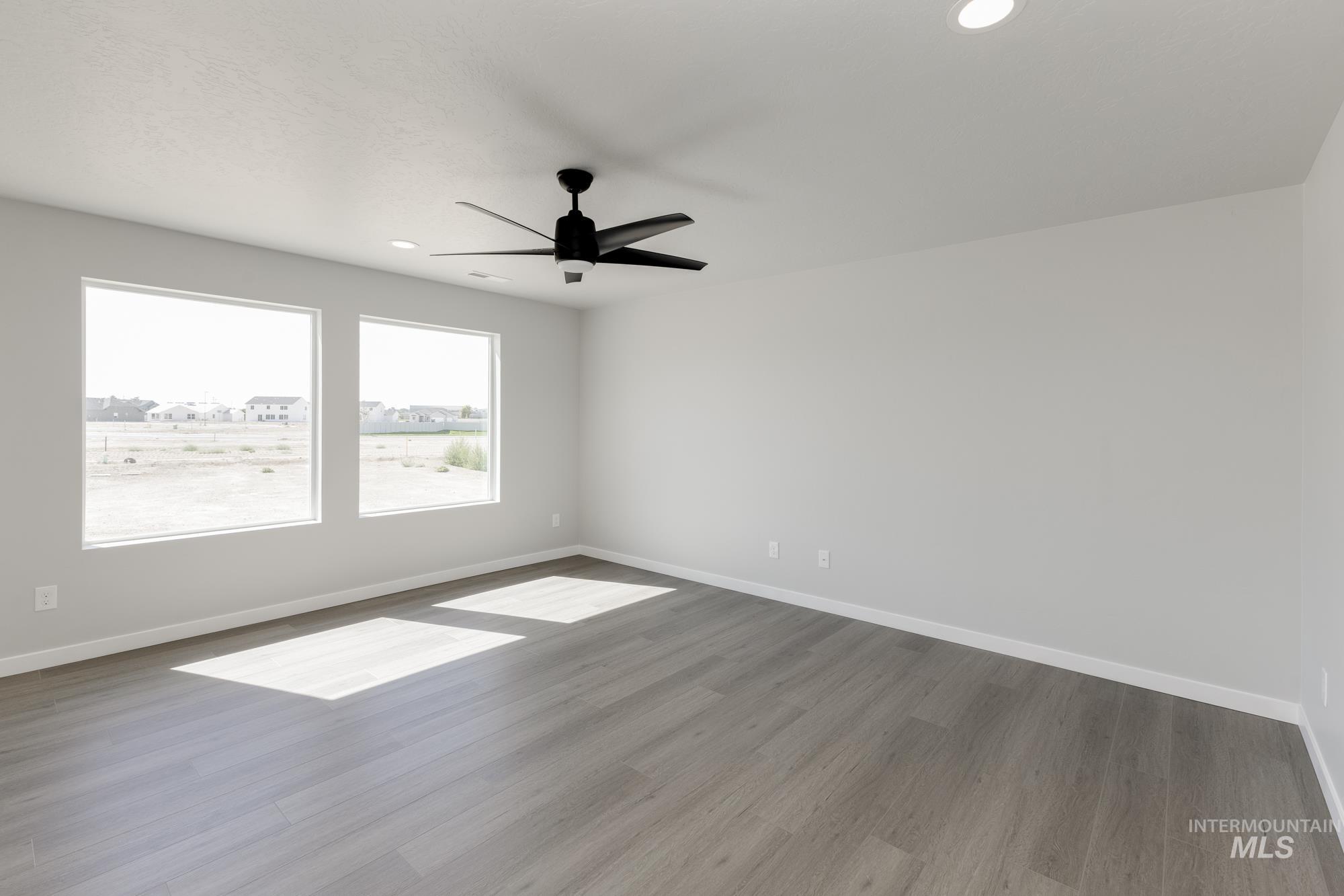 Unfurnished room with wood finished floors, recessed lighting, and a ceiling fan