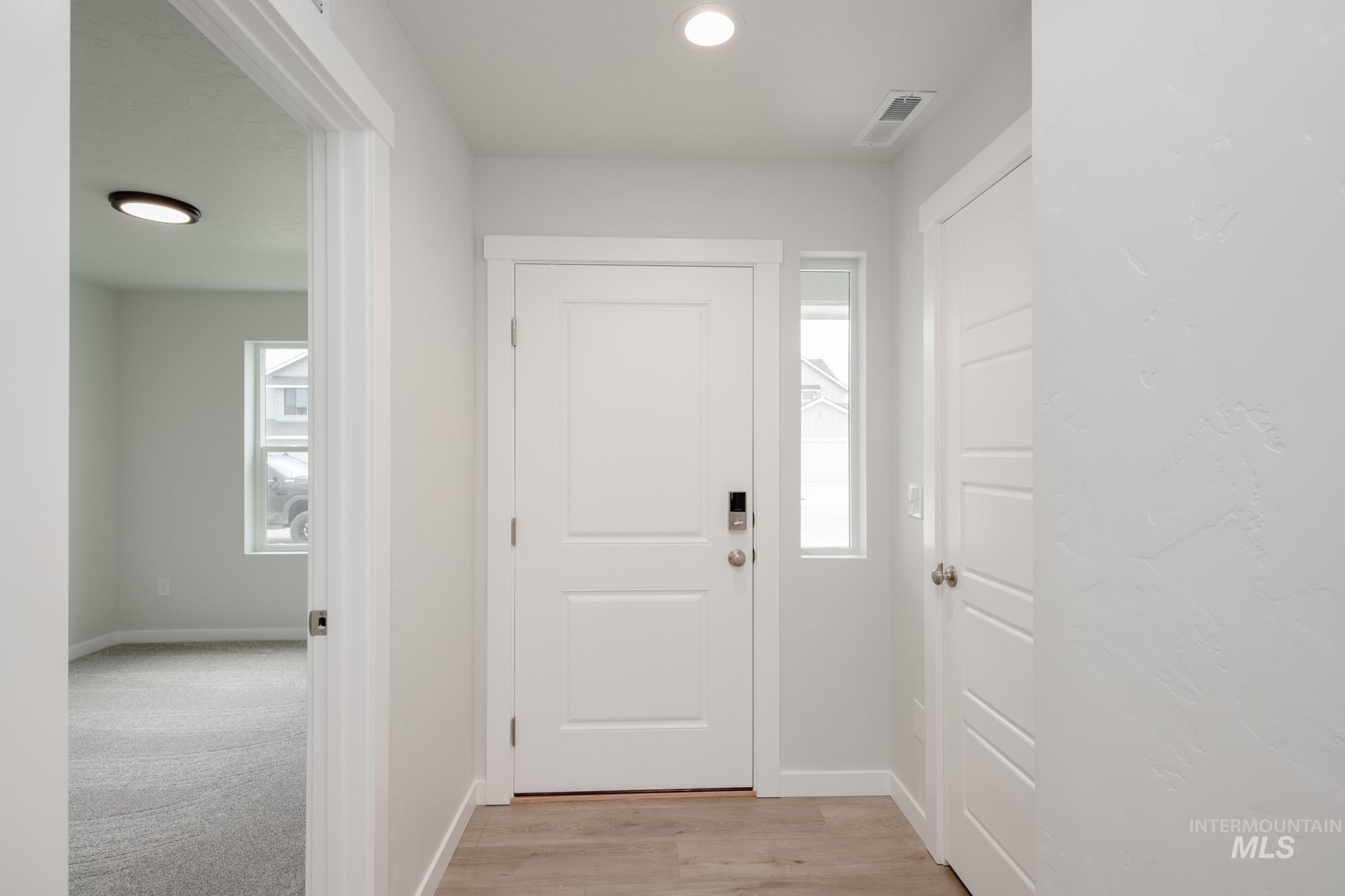 Foyer entrance featuring recessed lighting and light wood-style flooring
