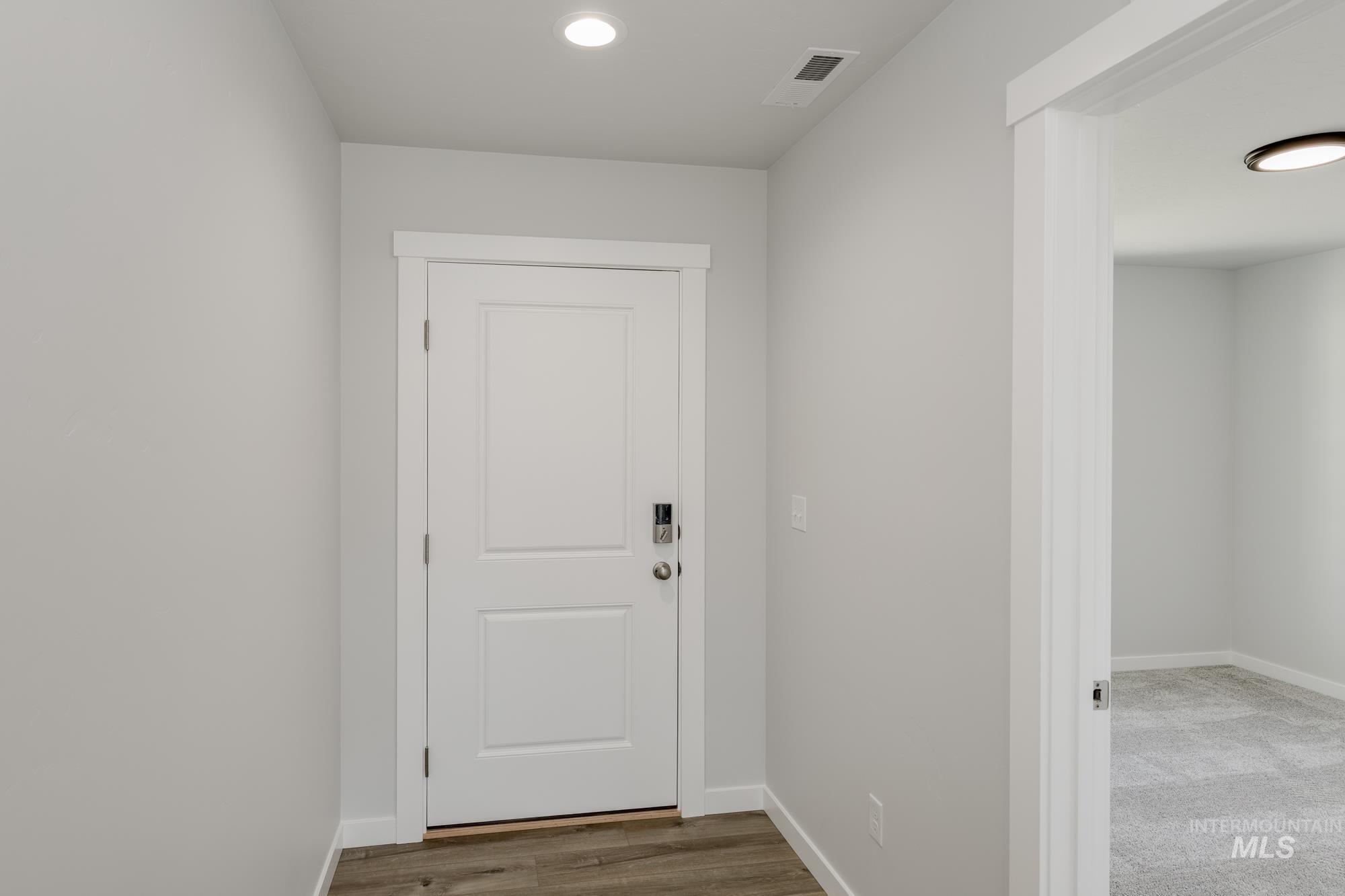 Doorway to outside featuring wood finished floors and recessed lighting