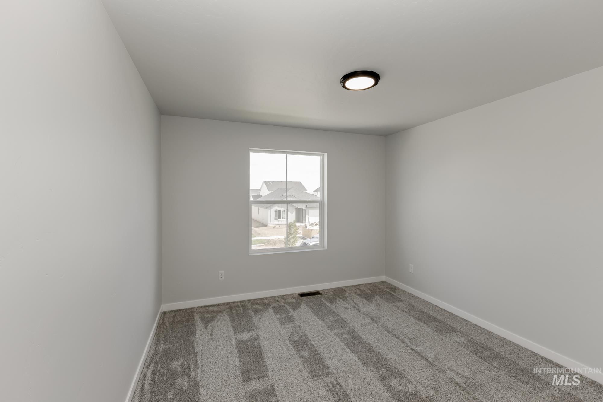 Unfurnished room featuring carpet flooring and baseboards