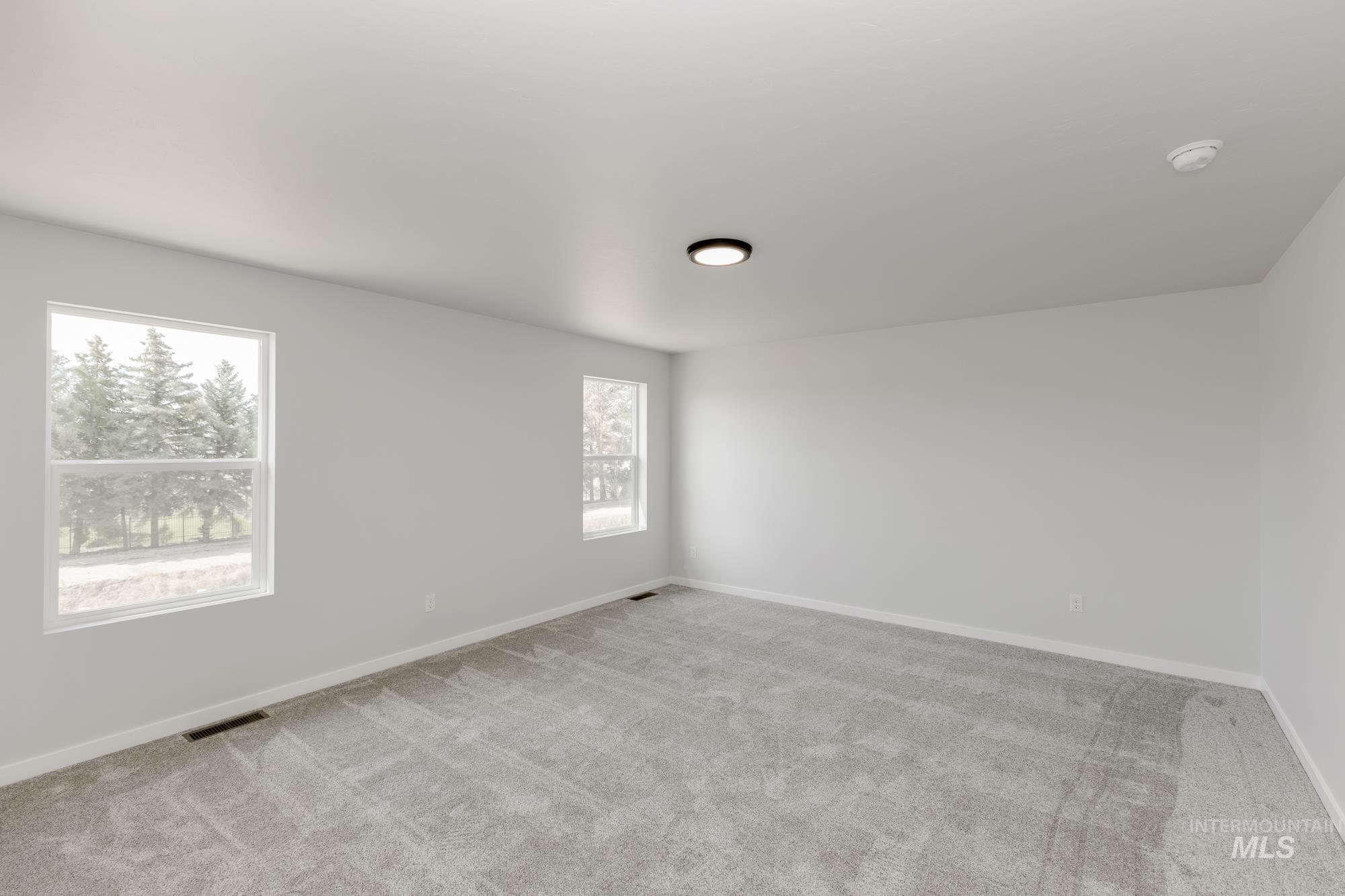 Unfurnished room with carpet flooring and baseboards