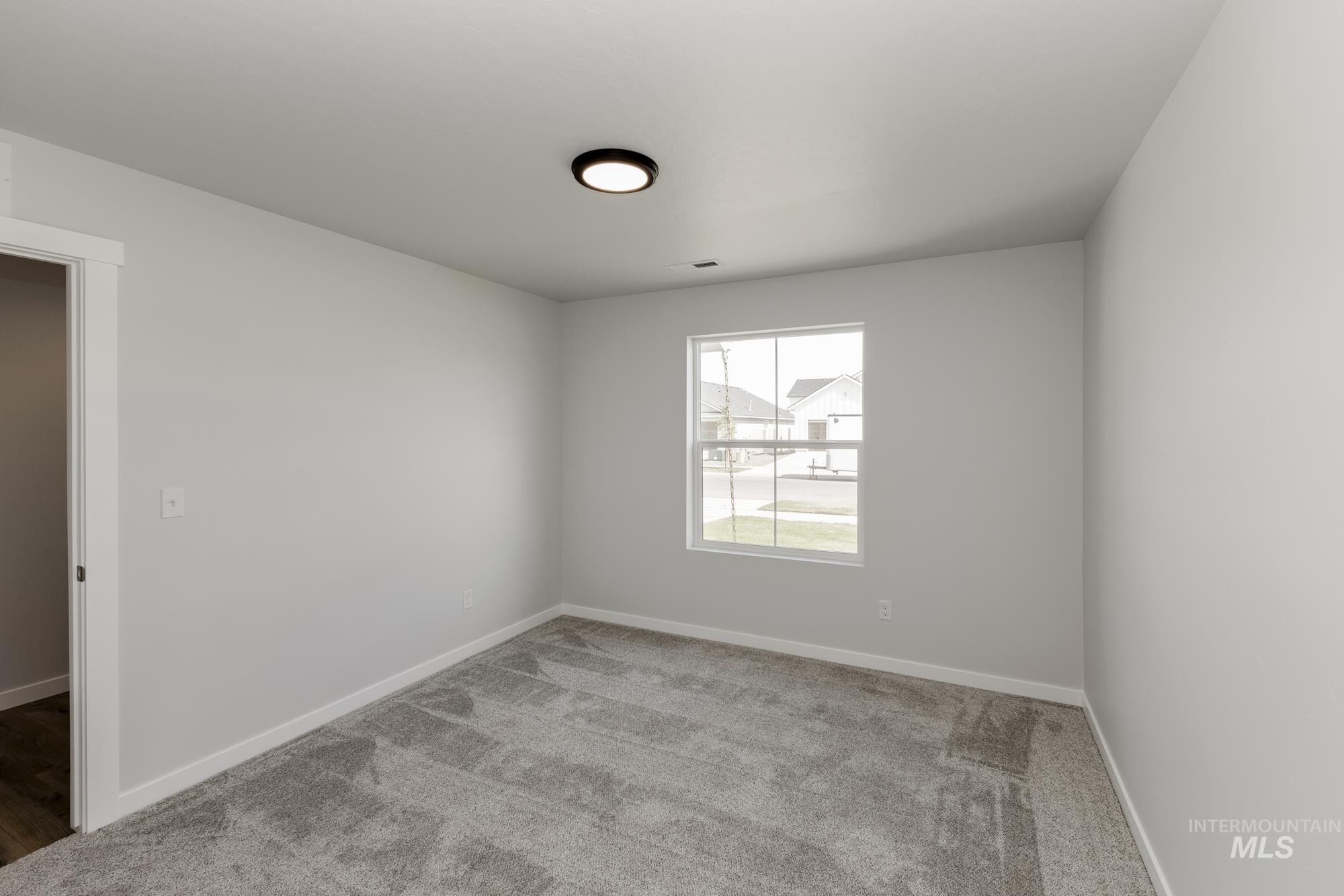 Unfurnished room featuring carpet flooring