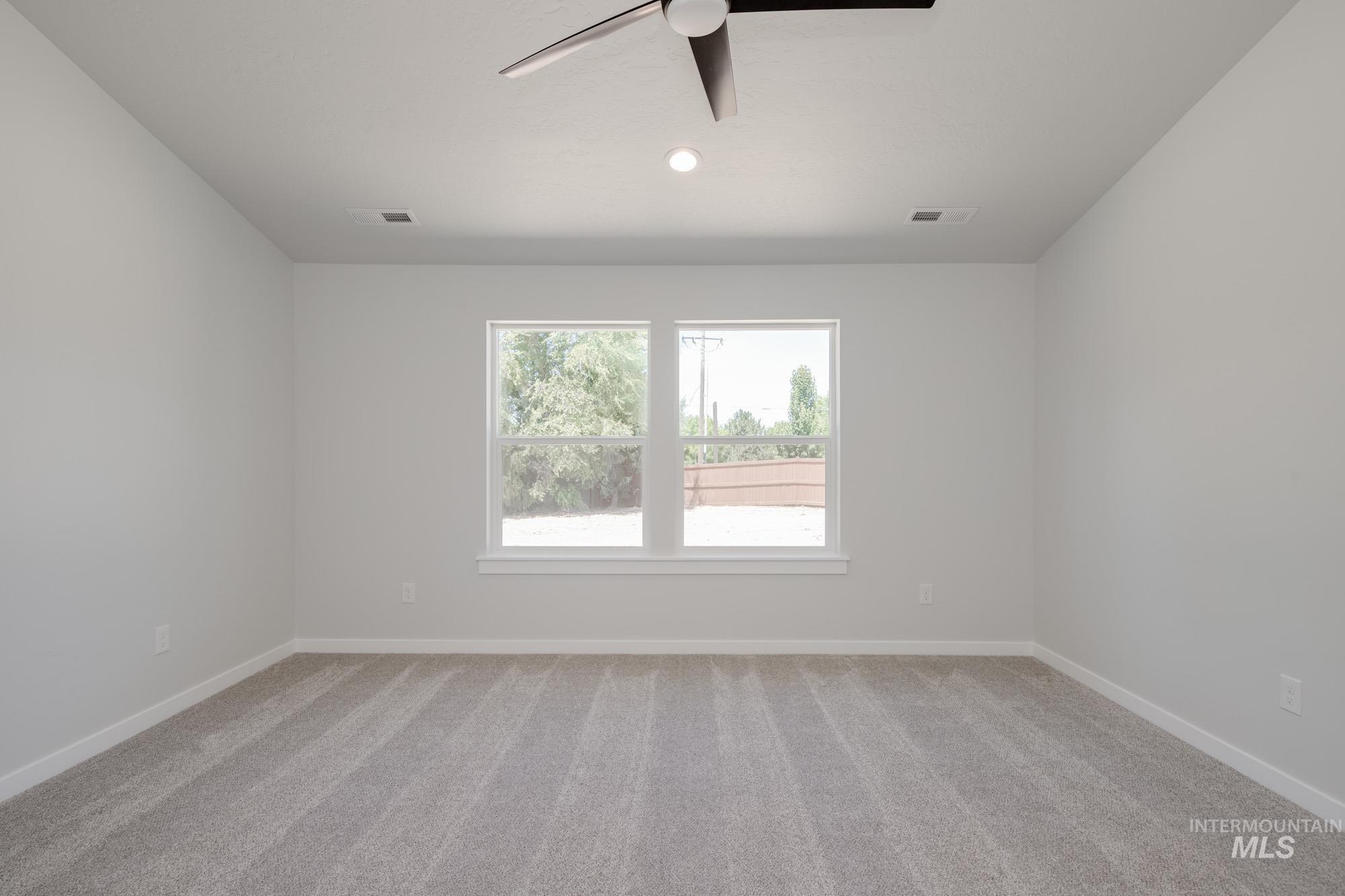 Unfurnished room with light carpet, a ceiling fan, and recessed lighting