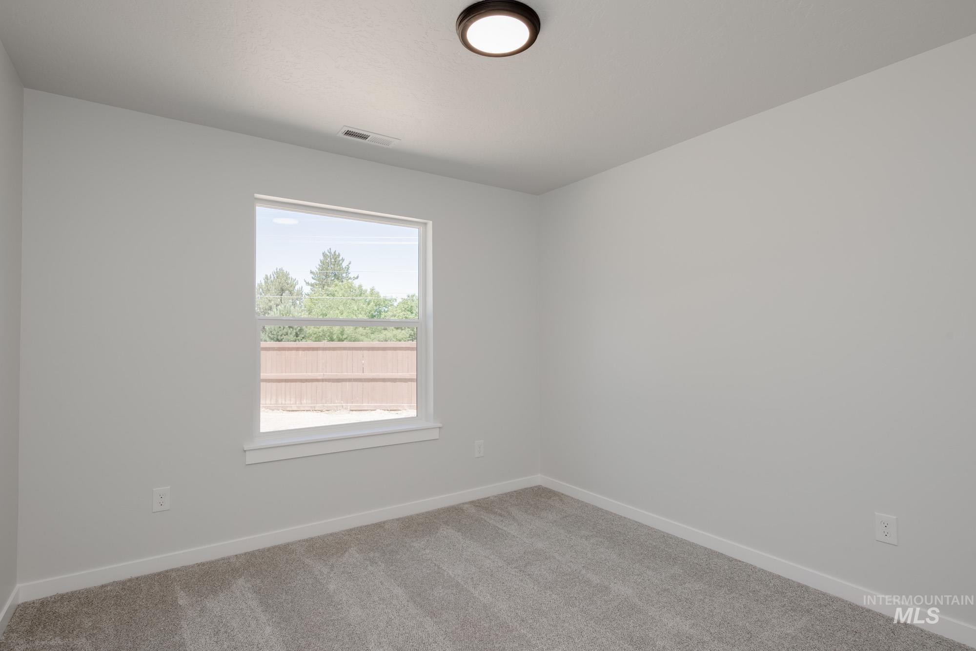 Empty room featuring carpet floors and baseboards