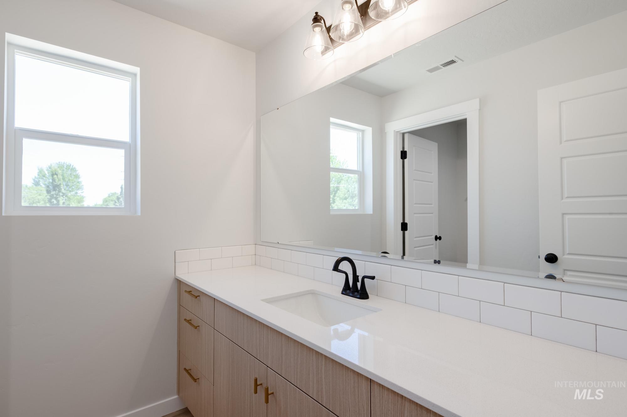 Bathroom with vanity and baseboards