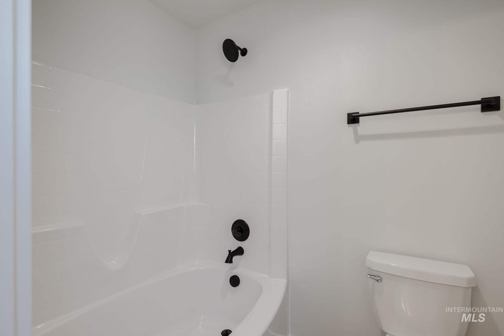 Bathroom featuring shower / bathtub combination and toilet