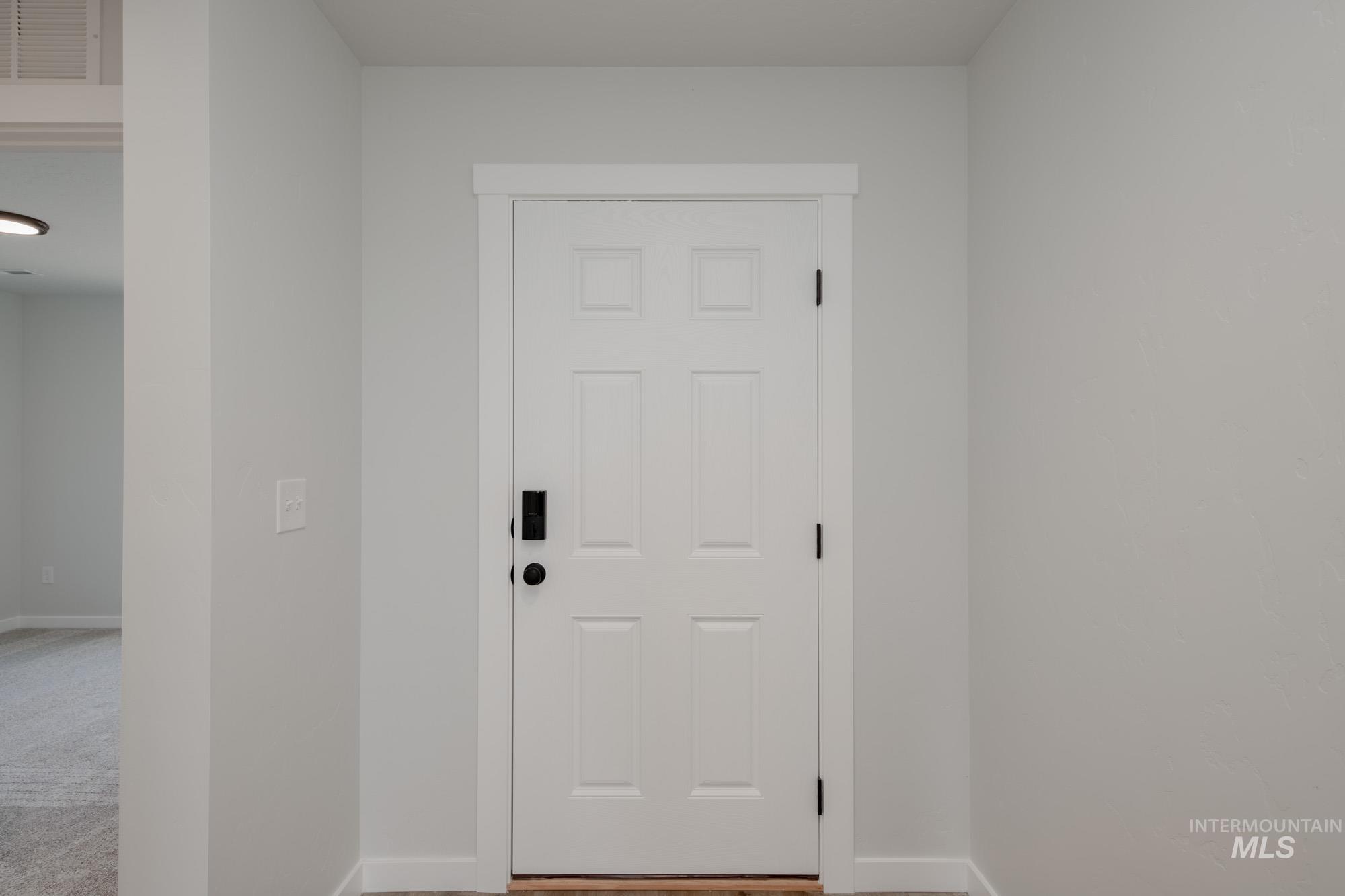 Doorway to outside featuring baseboards