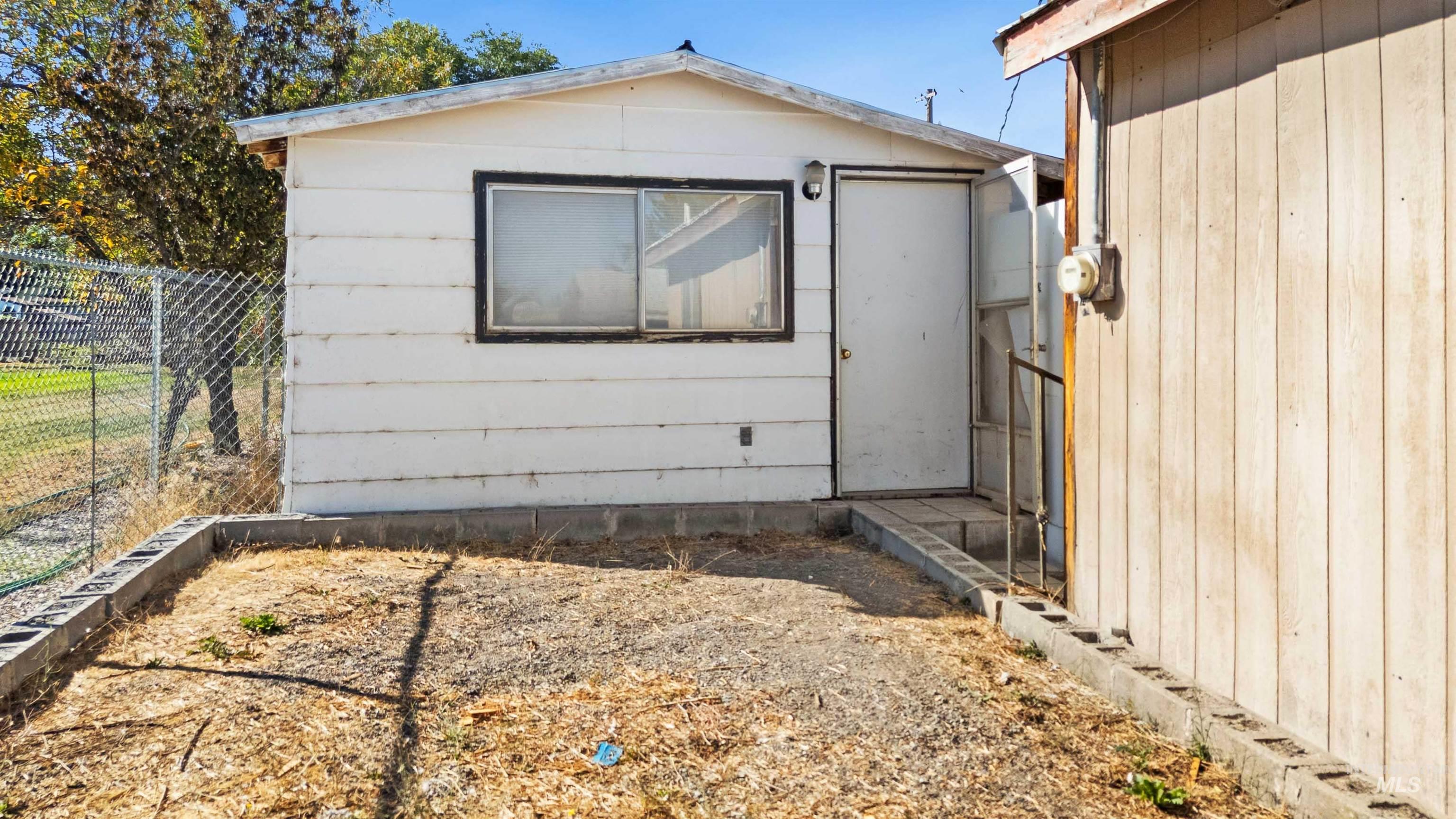 View of side of home featuring an outdoor structure