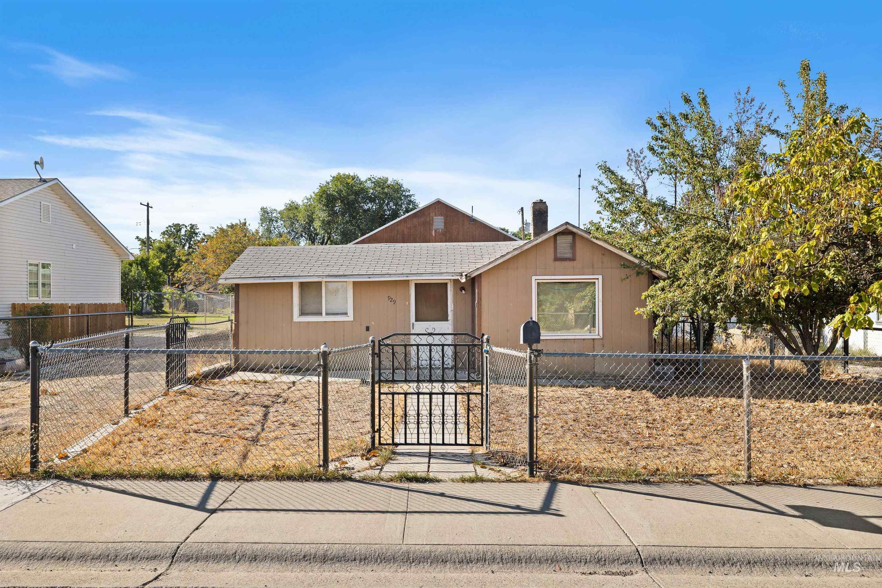 Bungalow-style house featuring a gate and a fenced front yard