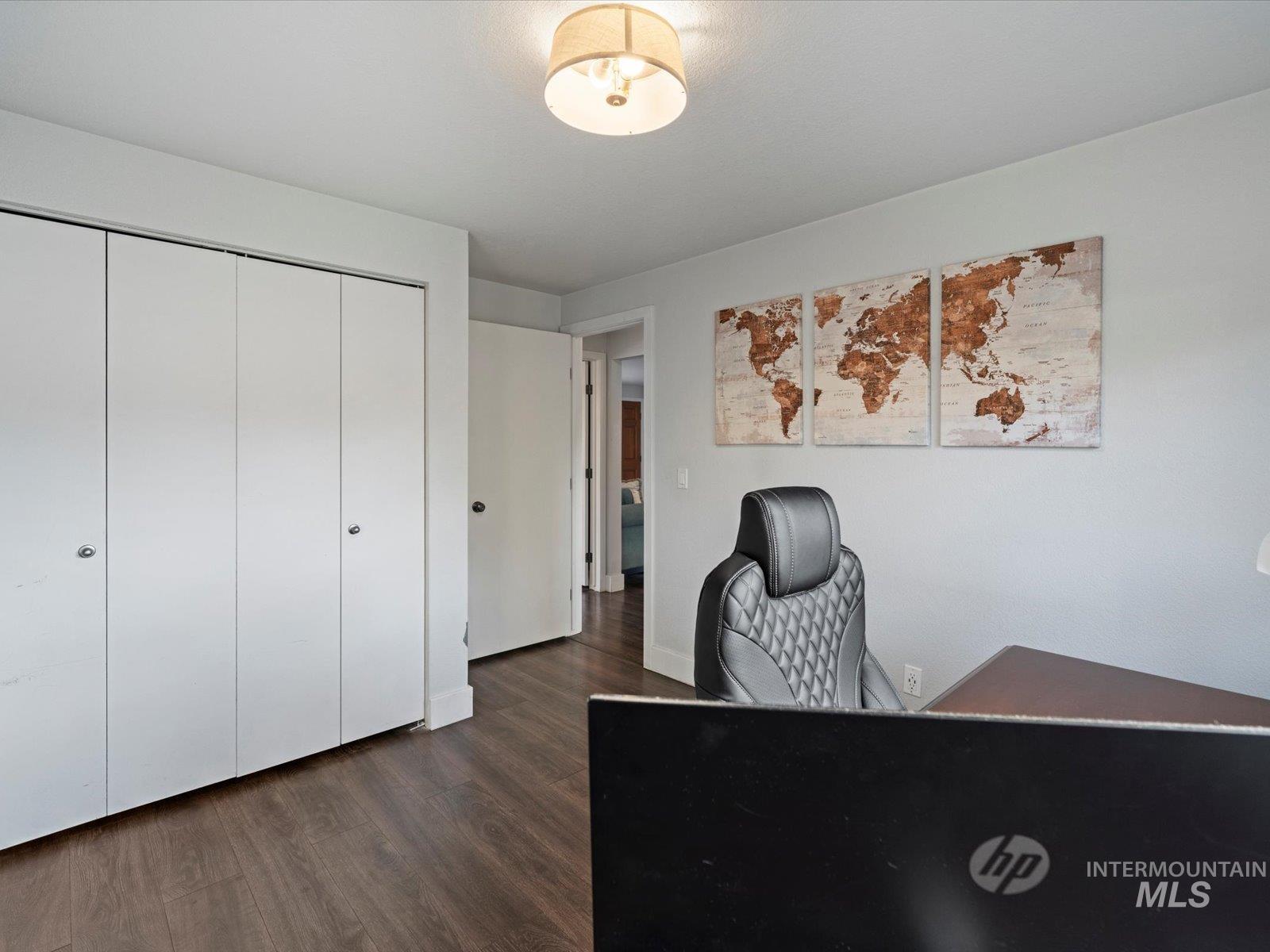 Office with dark wood finished floors and baseboards