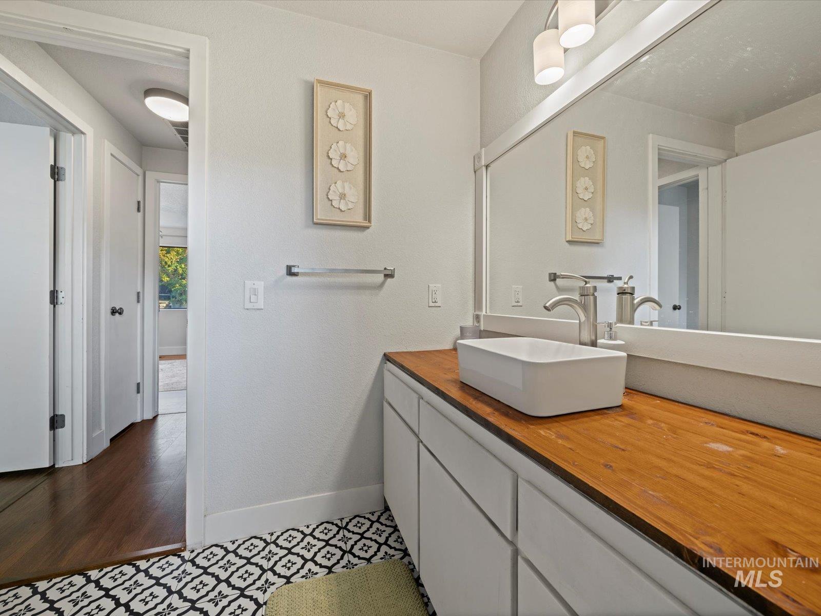 Bathroom with vanity and baseboards