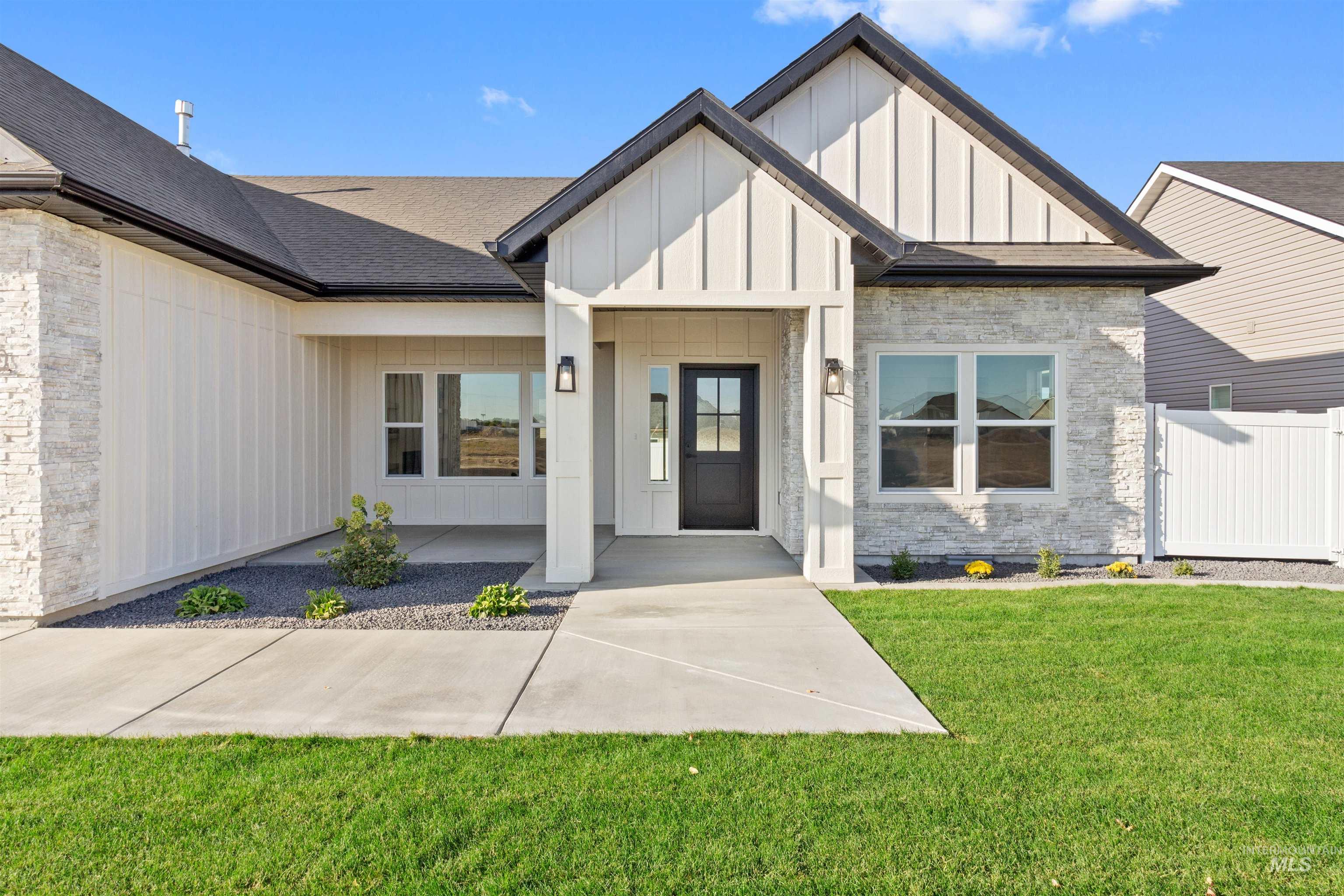 View of exterior entry featuring board and batten siding and stone siding