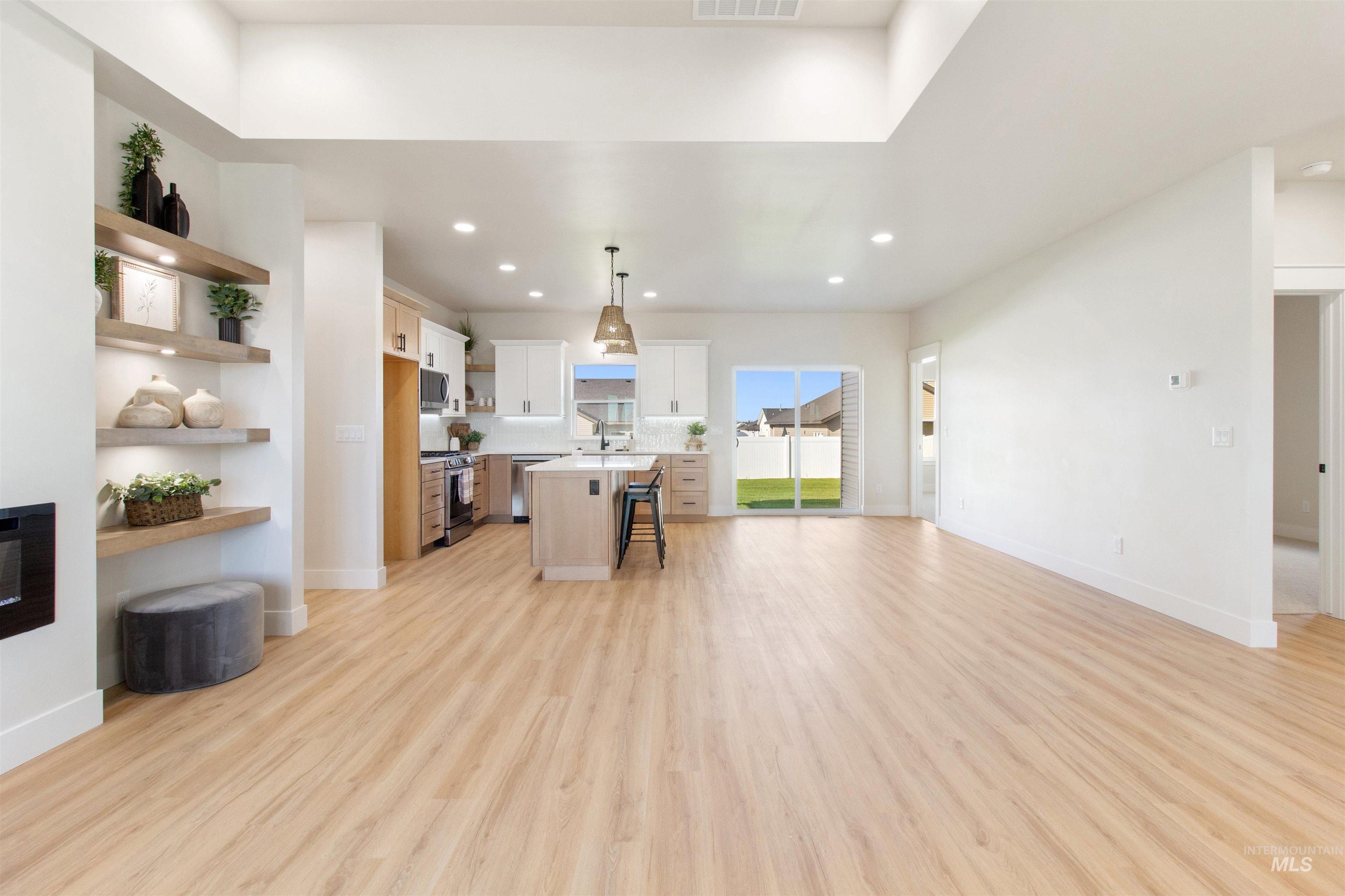 Living room with recessed lighting and light wood-style flooring
