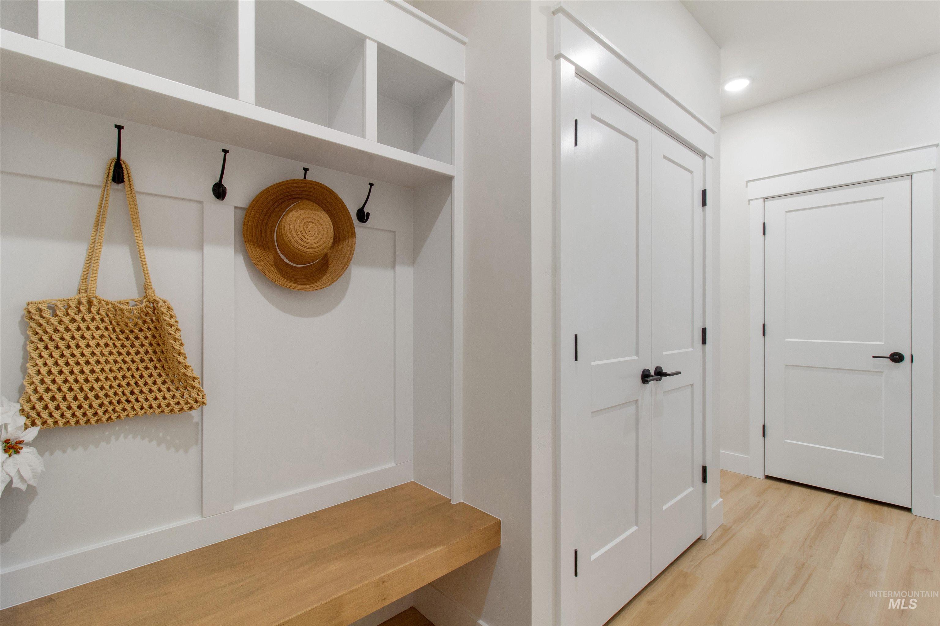 Mudroom with wood finished floors and recessed lighting