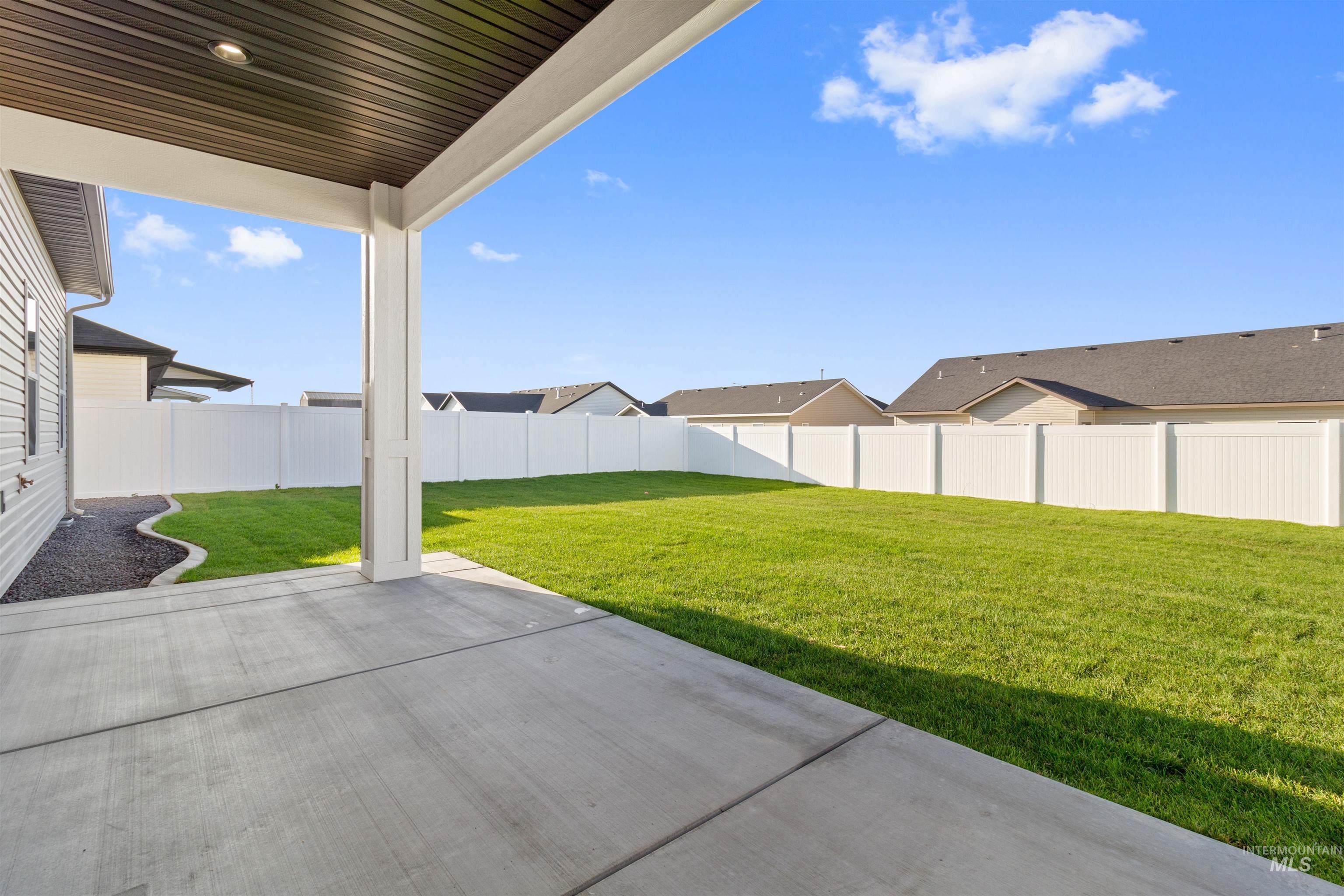 Fenced backyard with a patio area