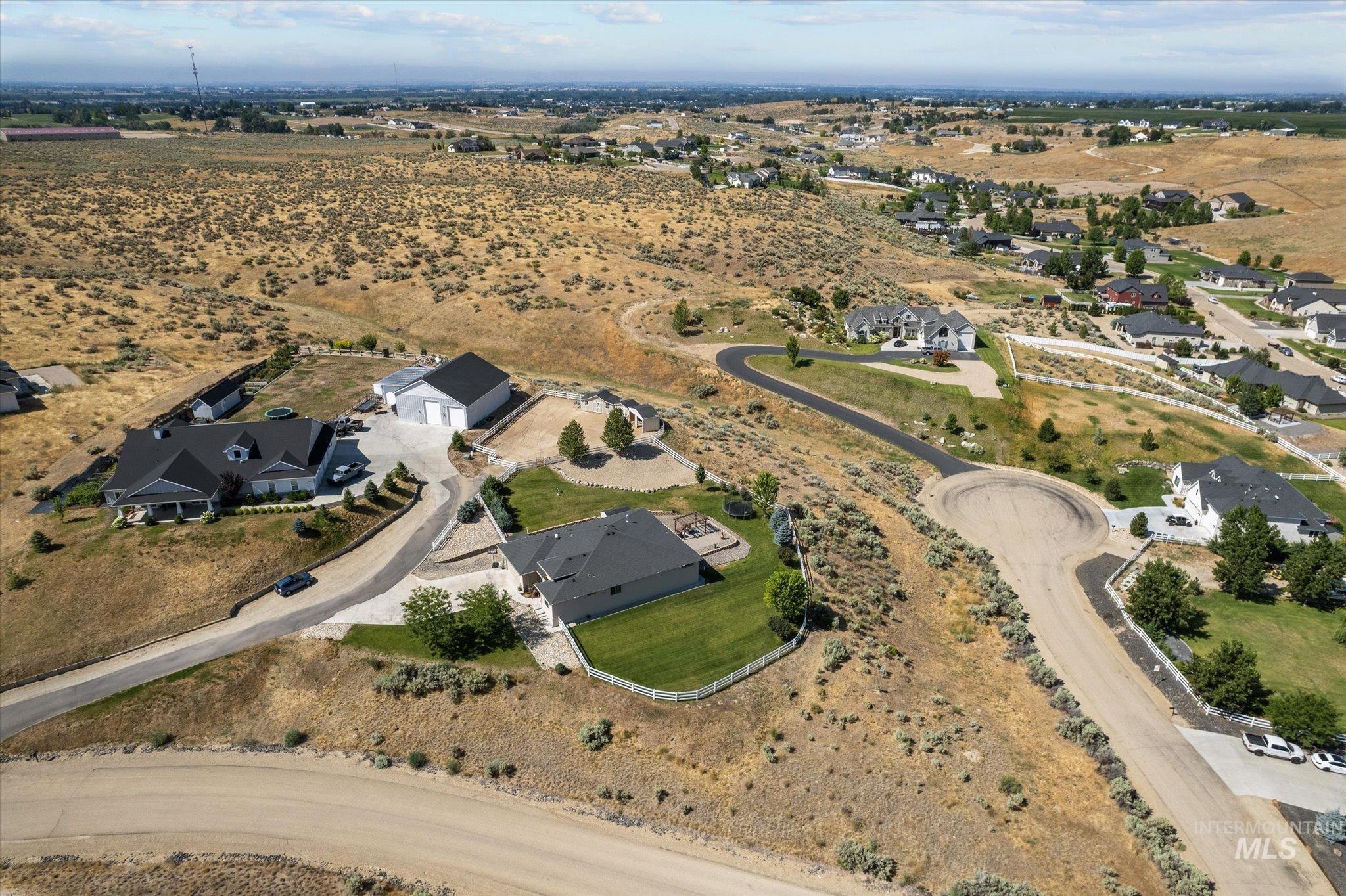 Aerial overview of property's location with rural landscape and nearby suburban area