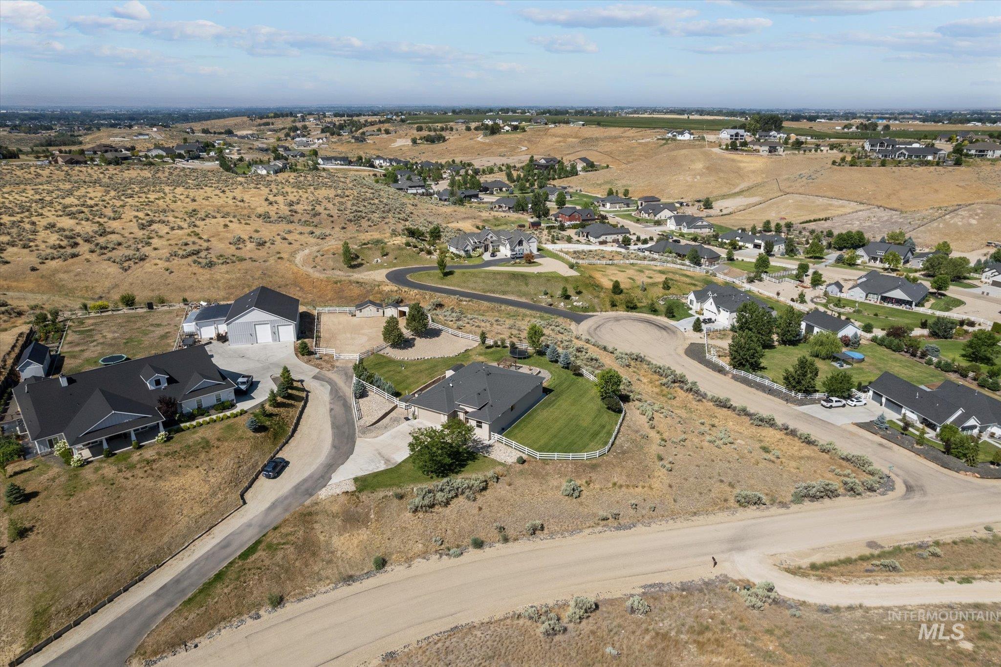 Aerial view of property and surrounding area with nearby suburban area and rural landscape