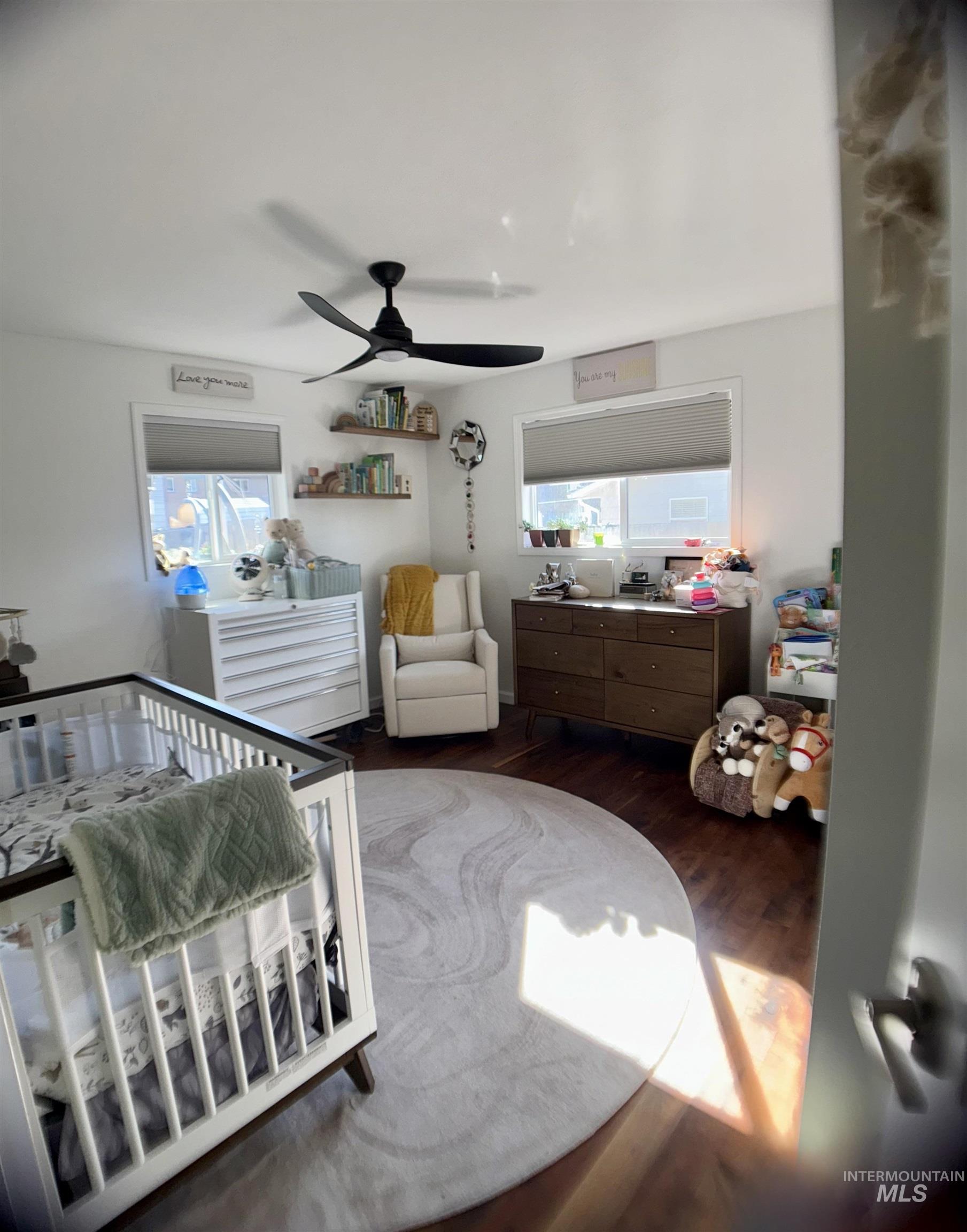 Bedroom featuring dark wood-type flooring and ceiling fan