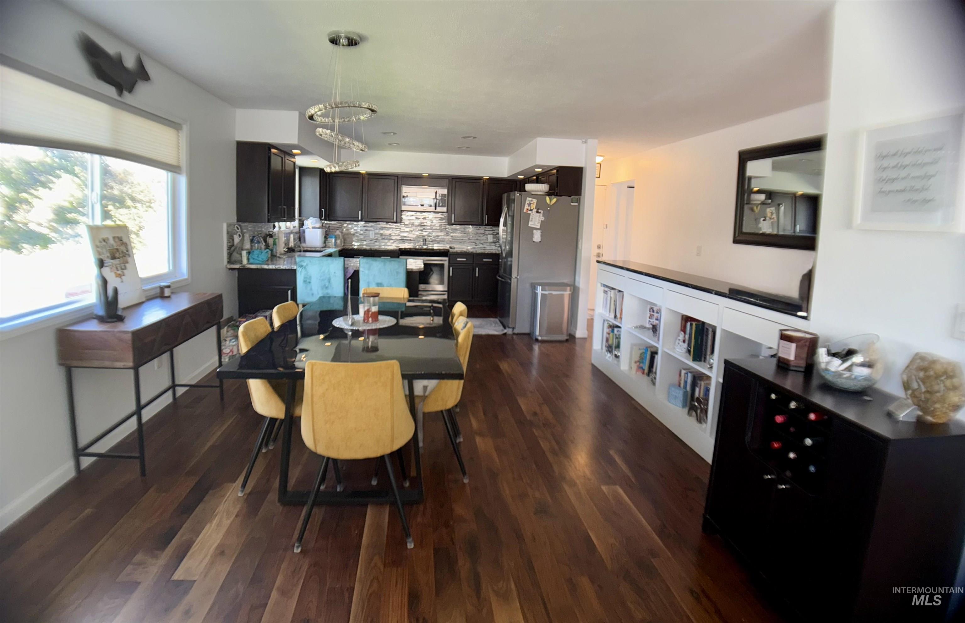 Dining area with dark wood finished floors