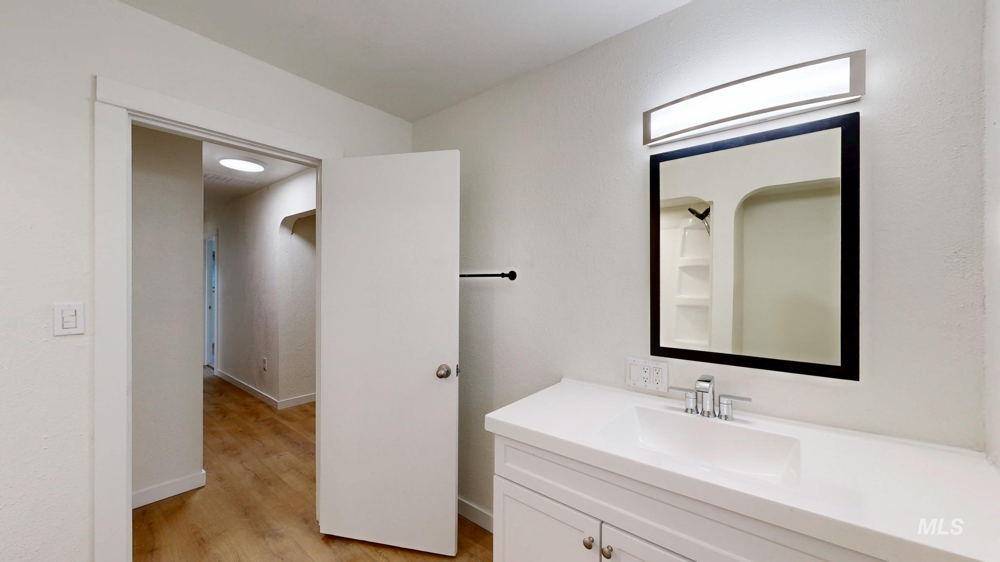Bathroom with vanity and light wood-style flooring