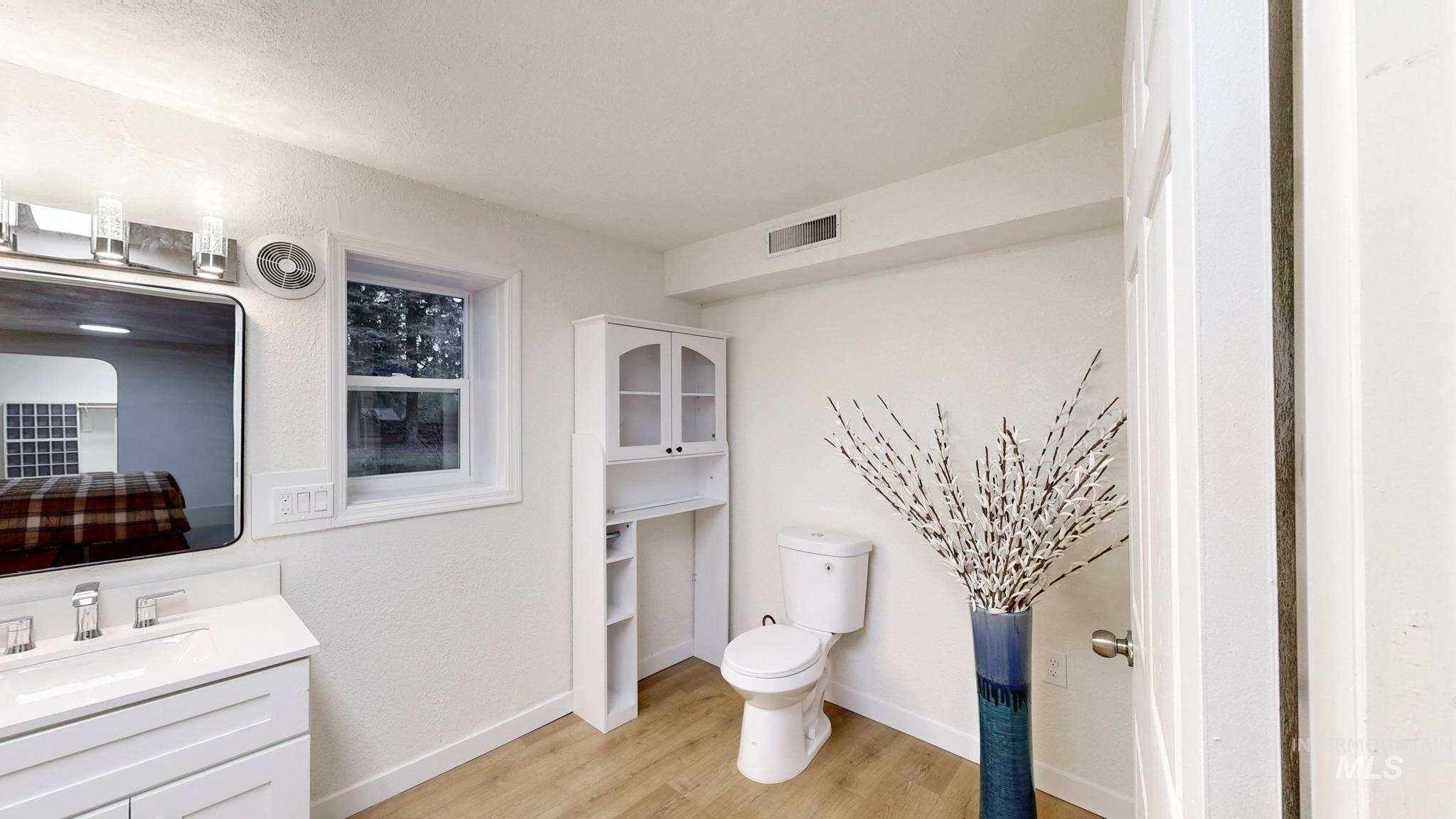 Bathroom featuring vanity and light wood-style flooring