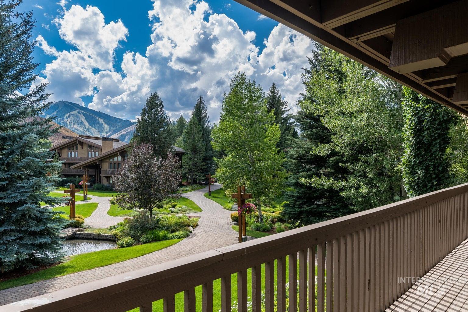 Balcony featuring a water and mountain view