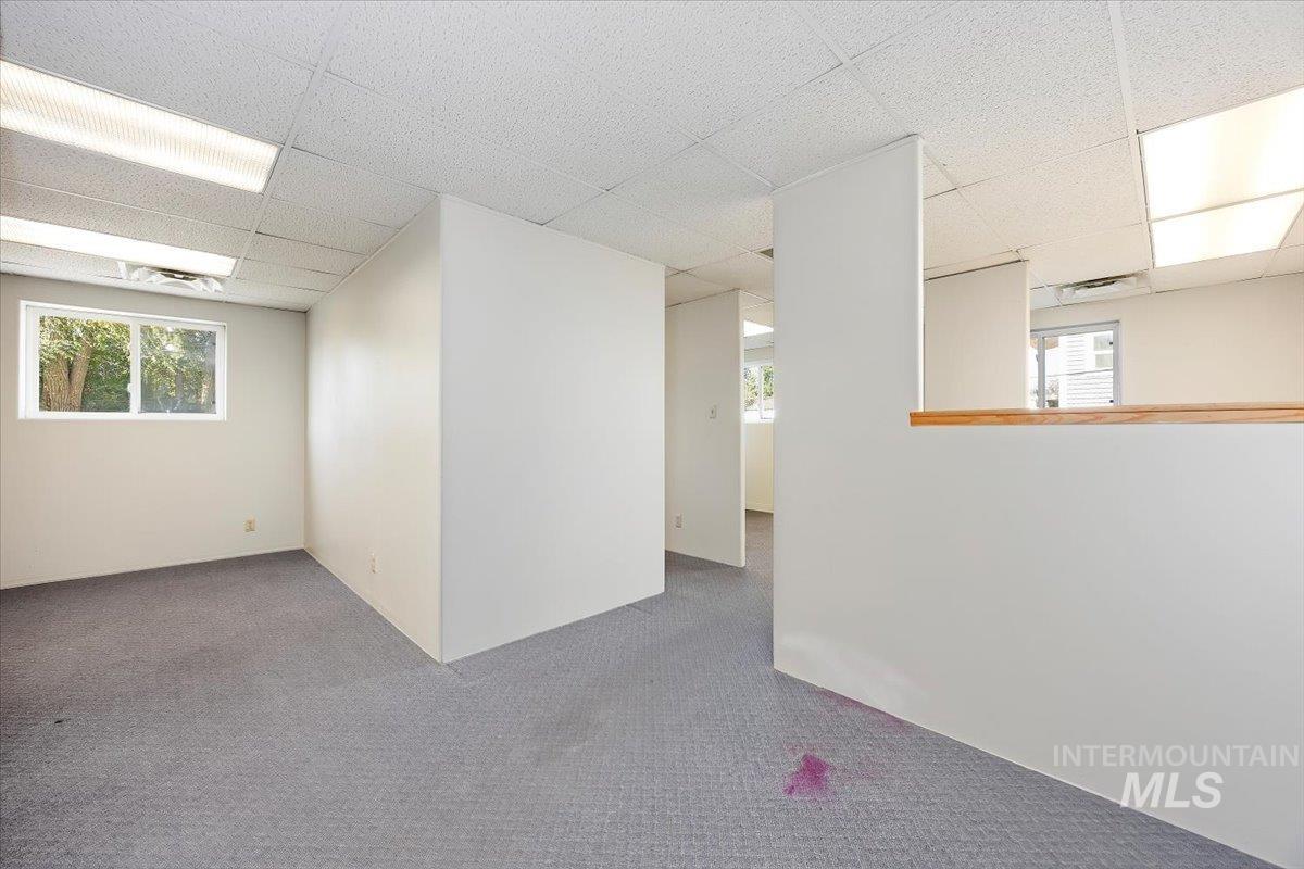 Carpeted empty room with a drop ceiling