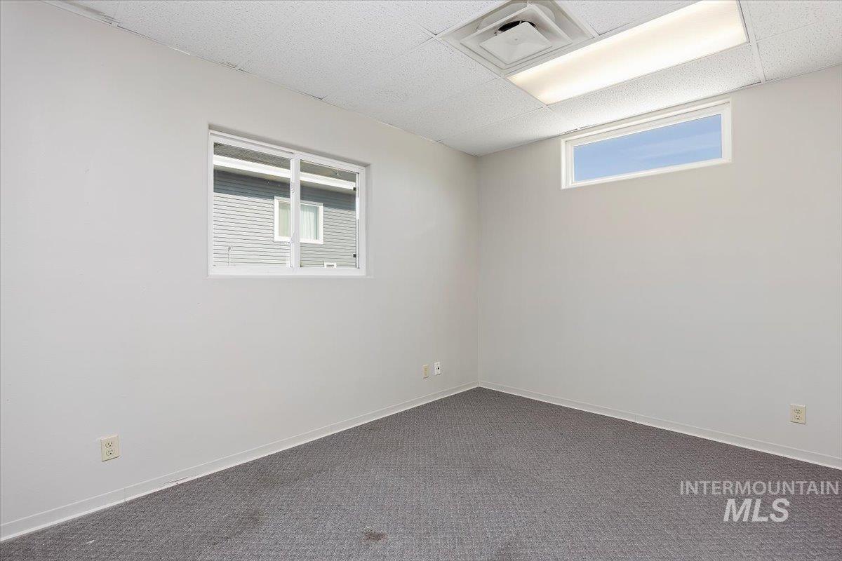 Spare room with carpet and baseboards