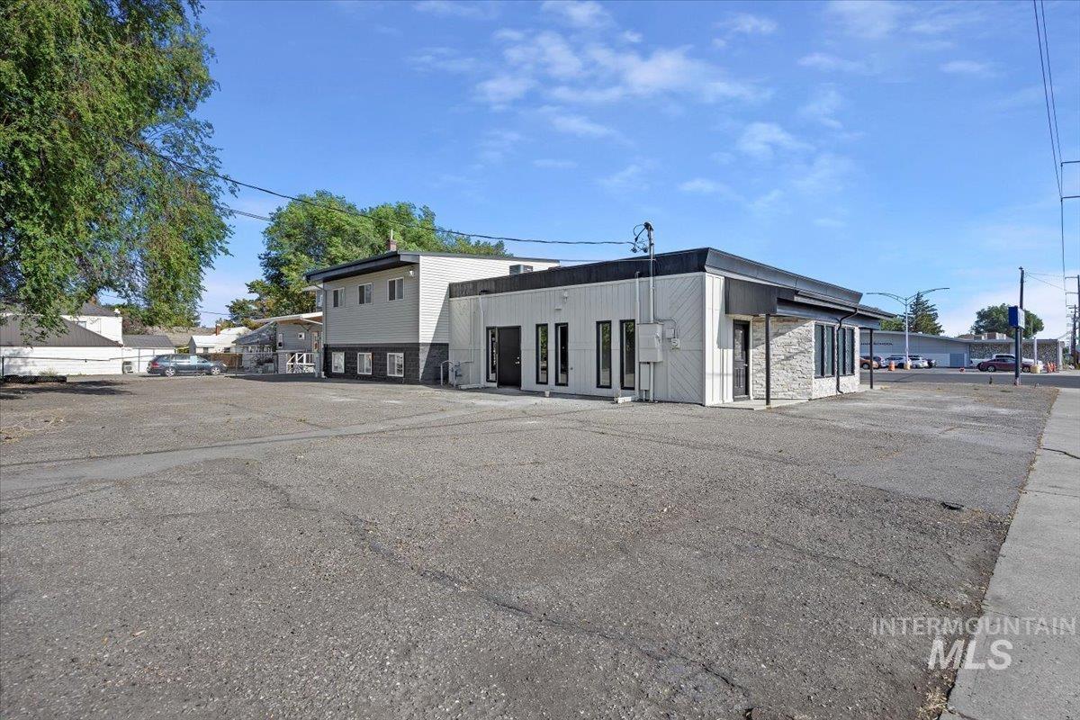 View of building exterior featuring uncovered parking