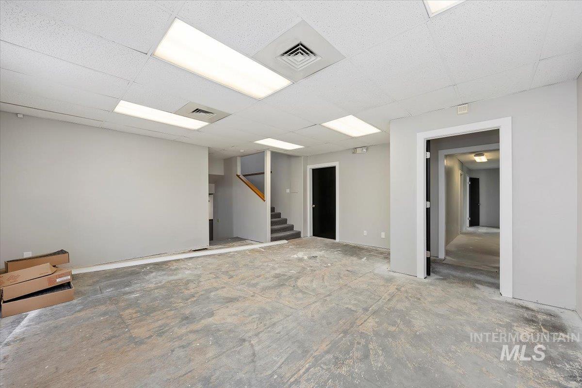 Below grade area featuring a paneled ceiling and baseboards
